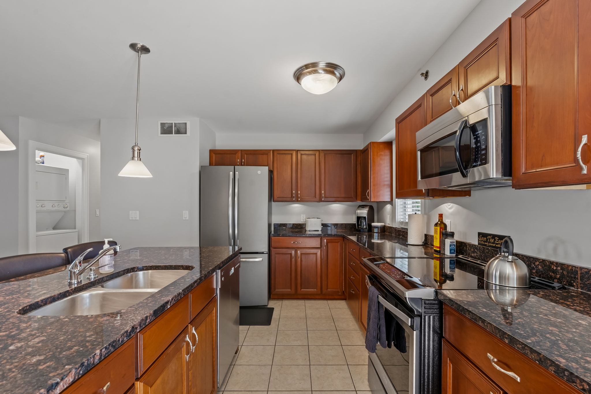 Spacious kitchen with island, granite counters, and stainless appliances