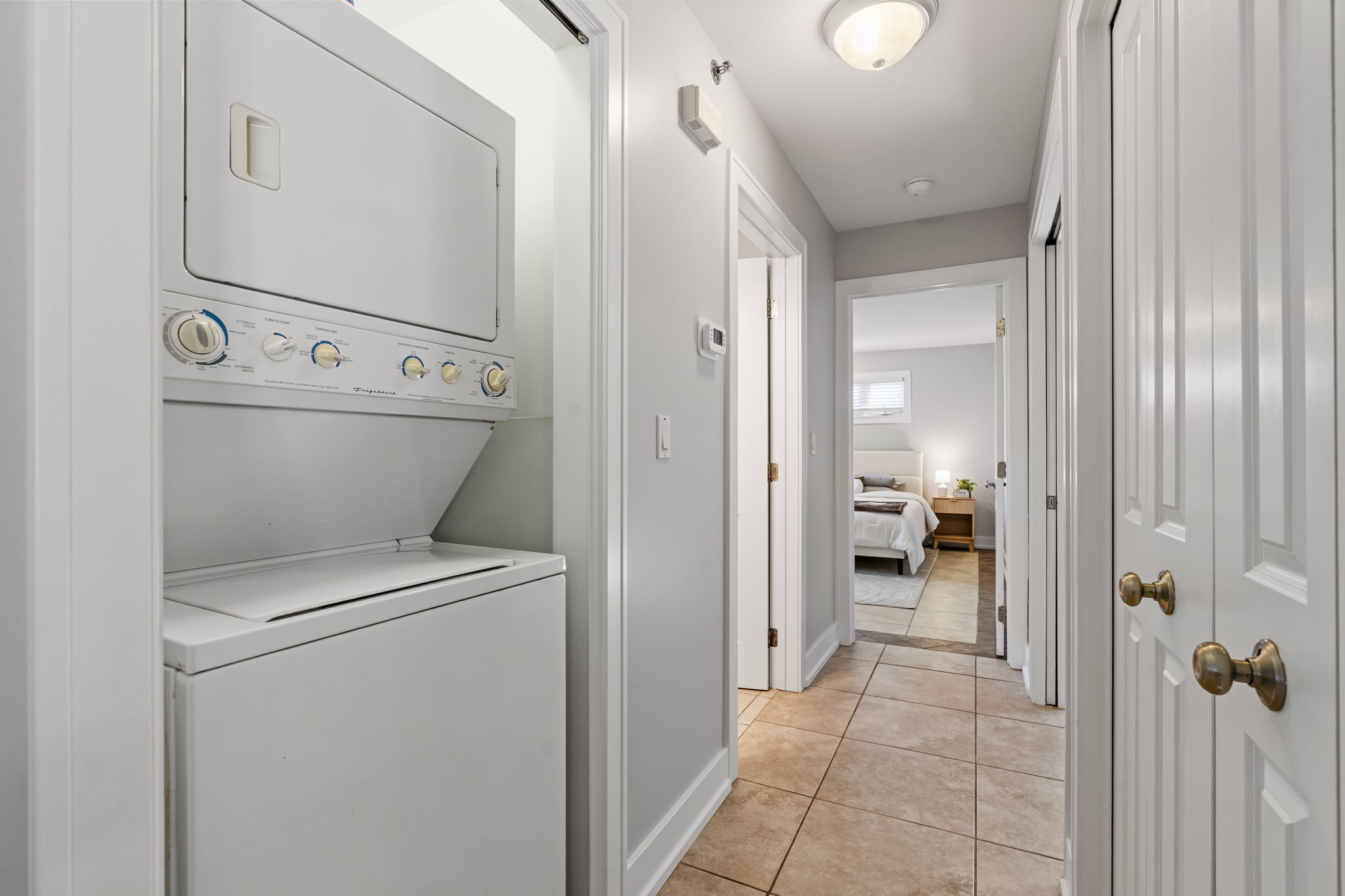 Convenient in-unit laundry and bright hallway leading to cozy bedrooms