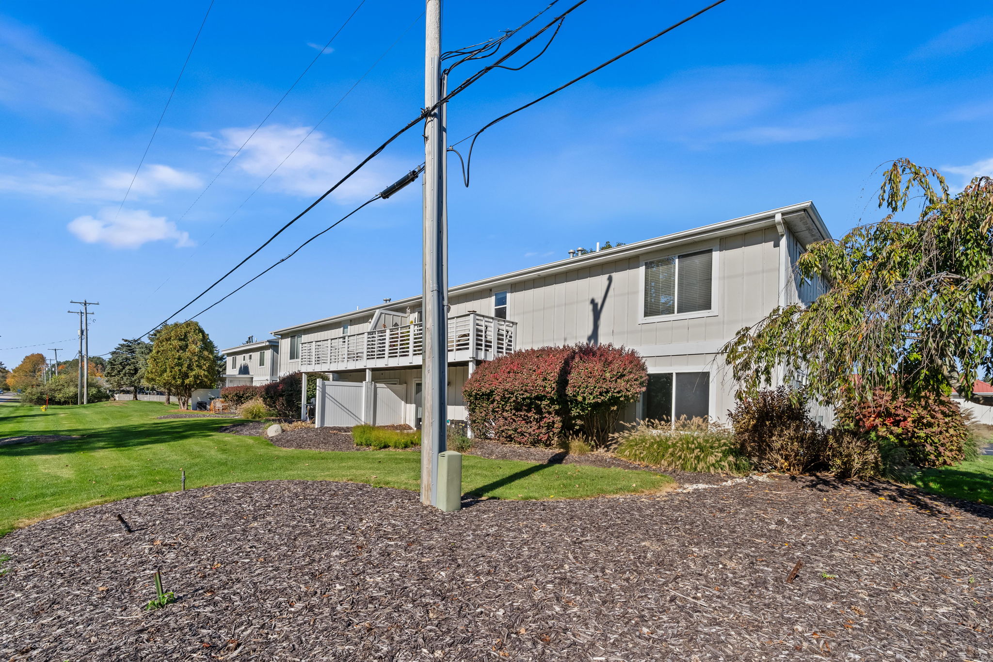 Spacious exterior with landscaped grounds and sunny balcony views