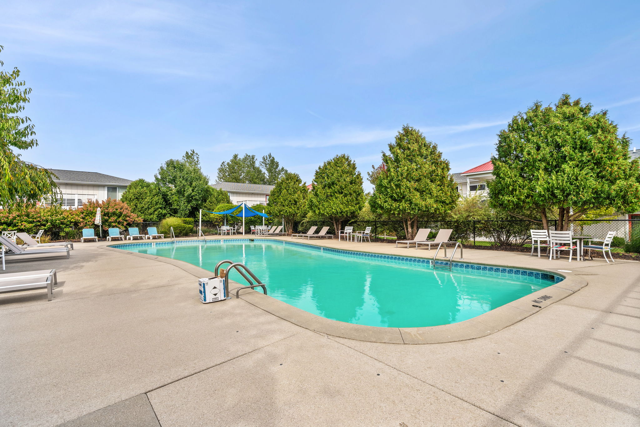 Relax by the spacious outdoor pool with loungers and sunny deck