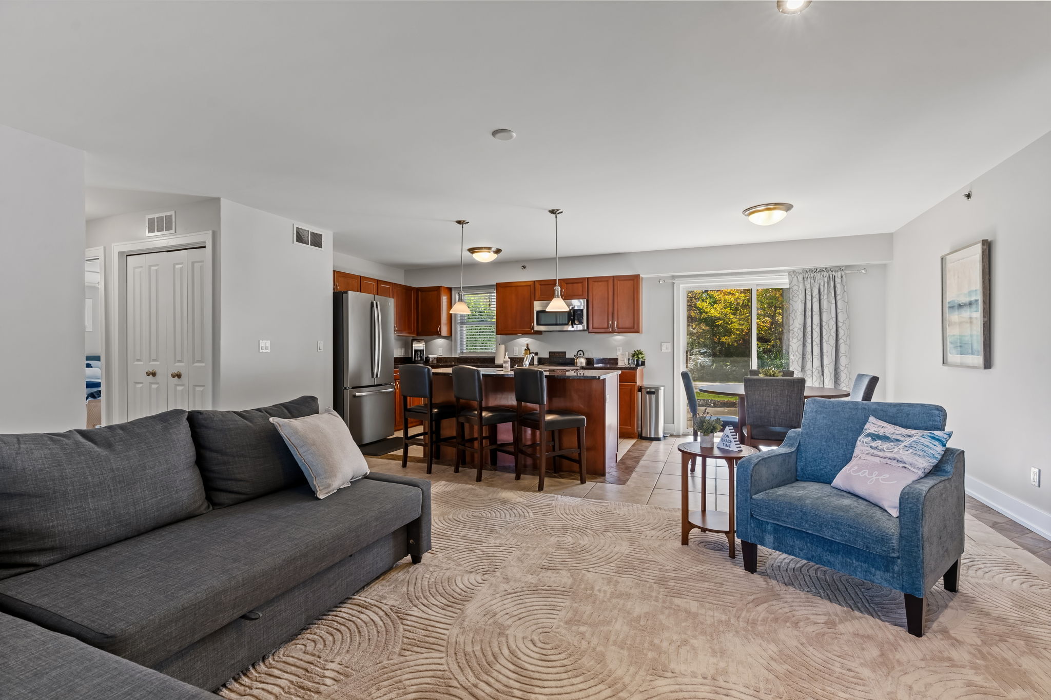 Bright open-concept living space with breakfast bar and cozy seating