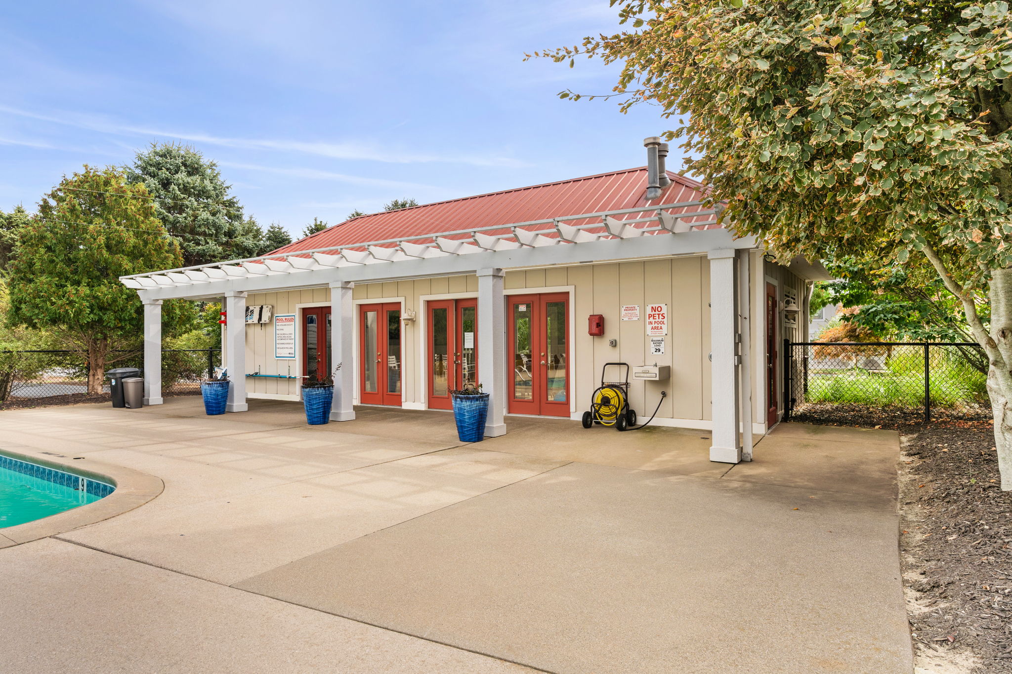 Private poolside patio with covered seating and spacious outdoor deck