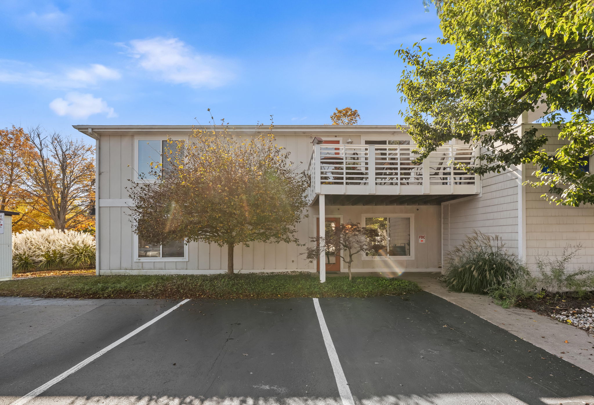 Bright condo exterior with private balcony and easy front parking
