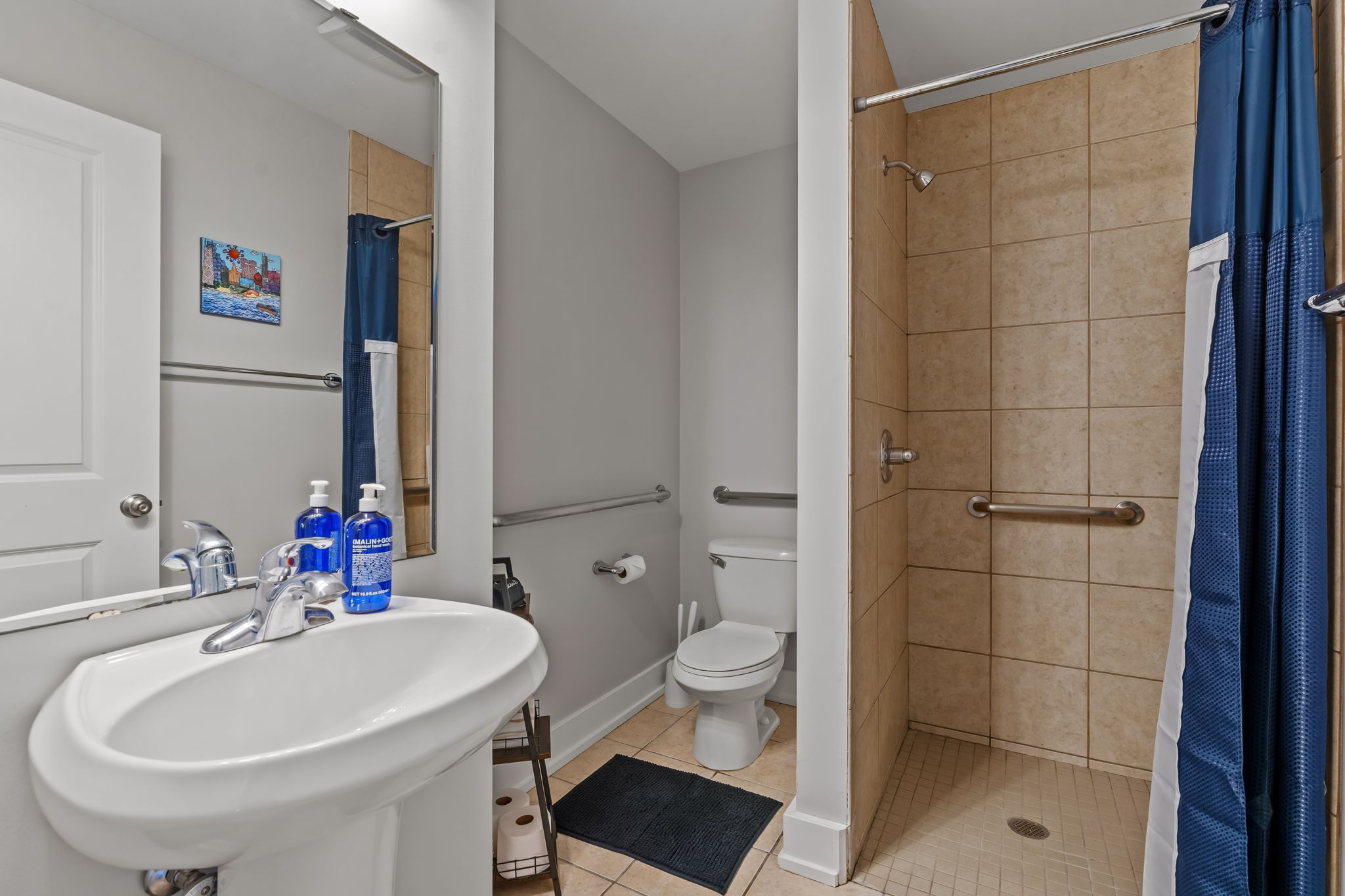 Spacious accessible bathroom with walk-in tiled shower