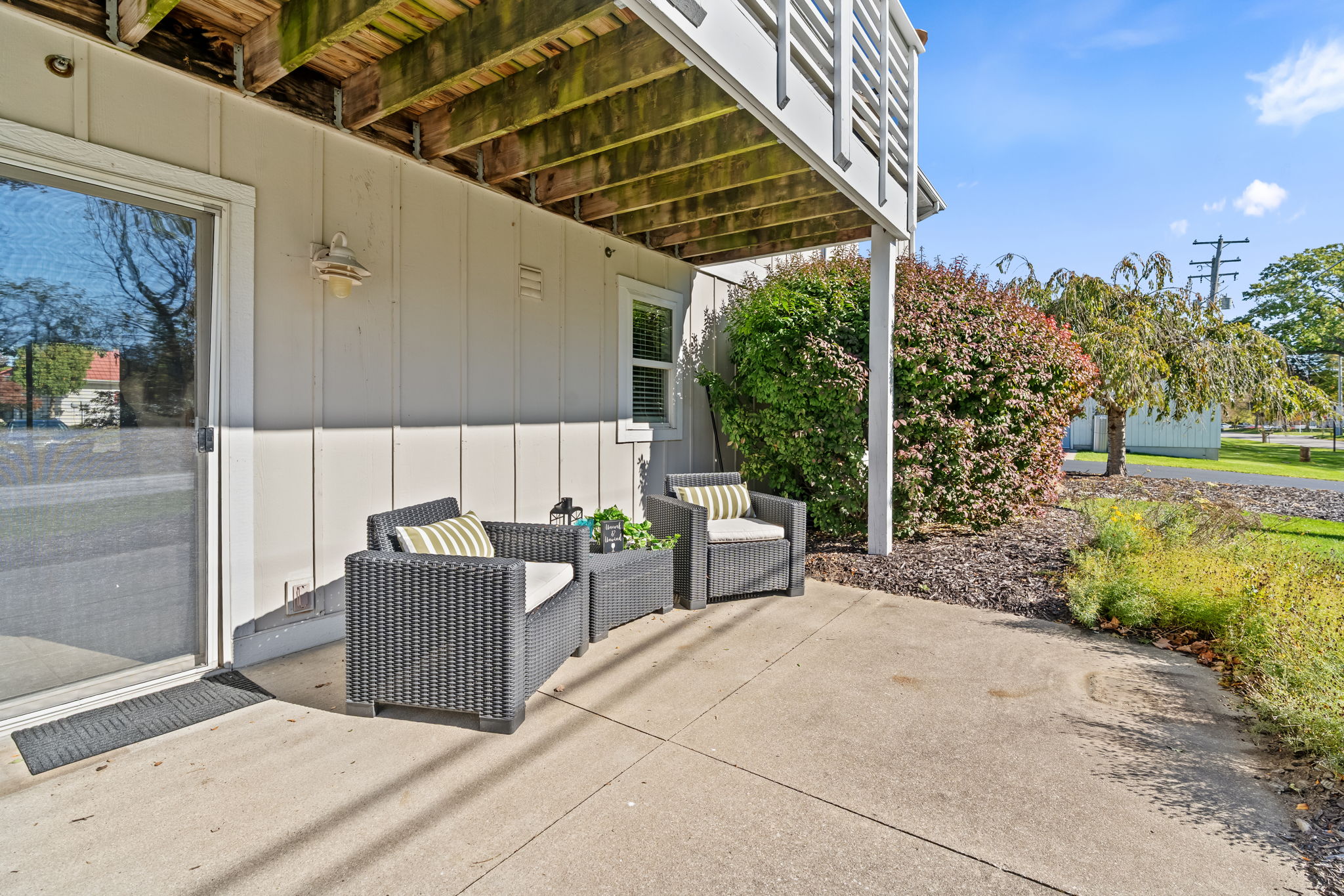 Shaded private patio with cozy seating and easy outdoor access