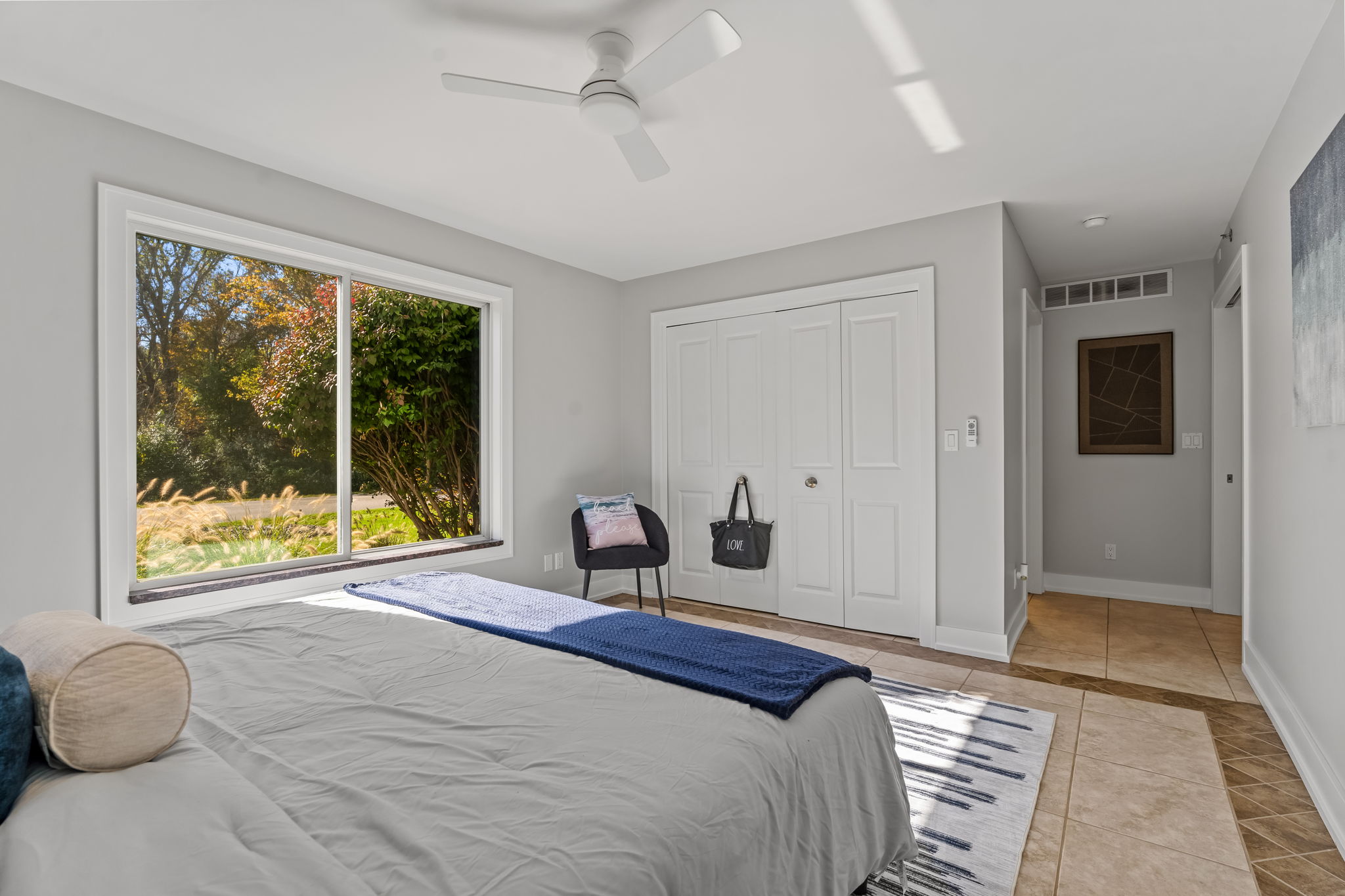 Bright, serene bedroom with garden views and abundant natural light
