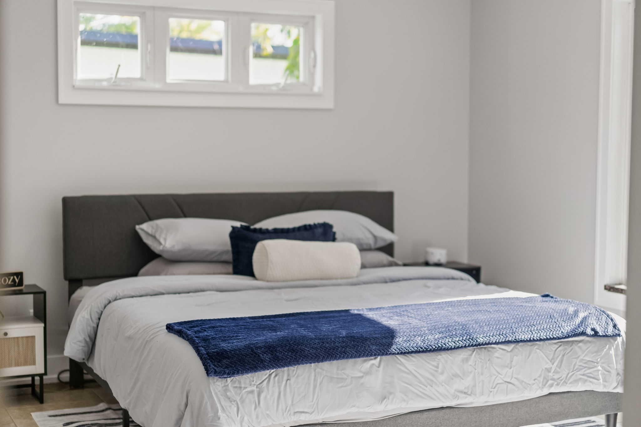 Bright, serene bedroom with plush bedding and modern minimalist style