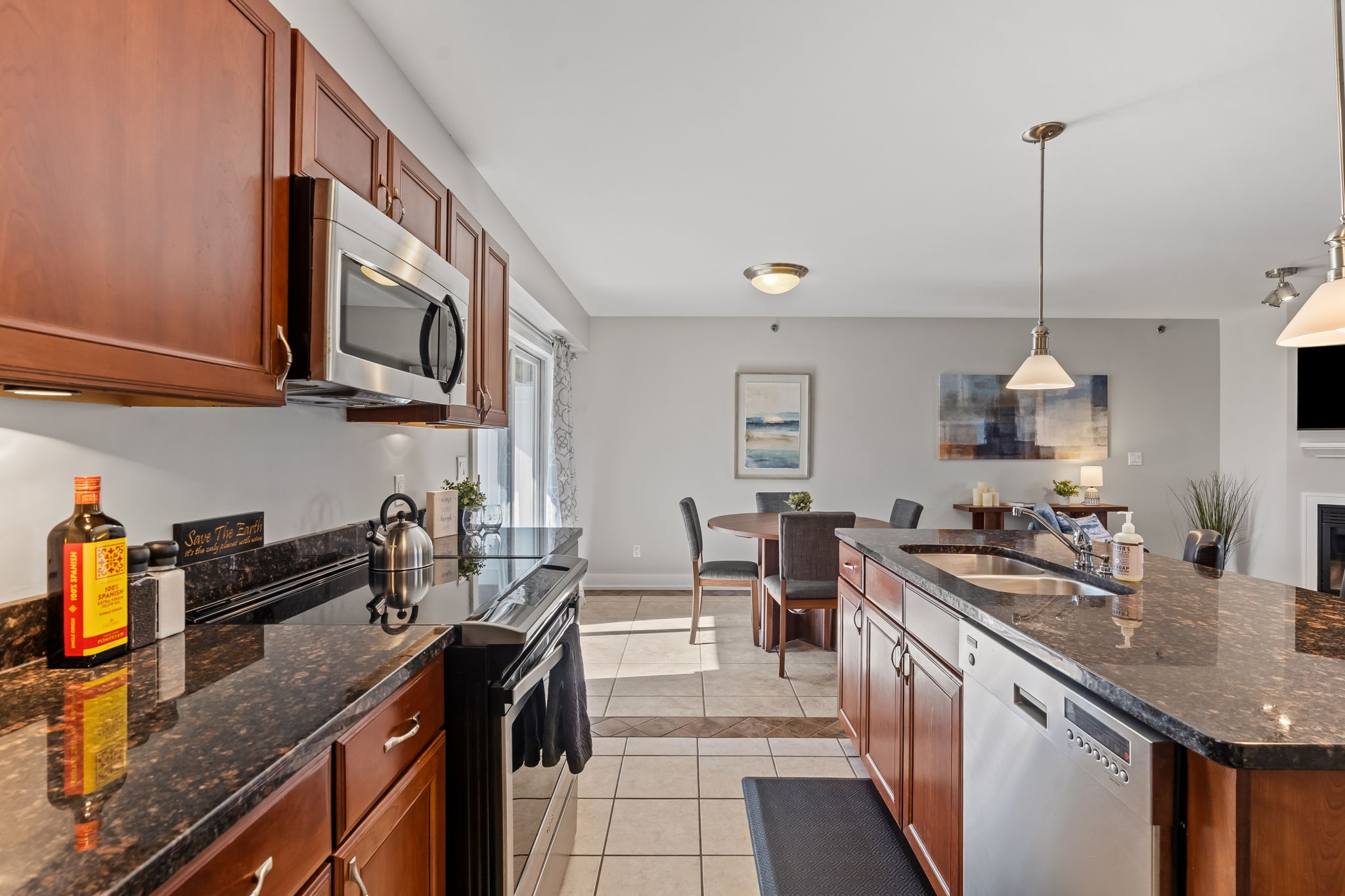 Spacious granite kitchen with stainless appliances and dining area