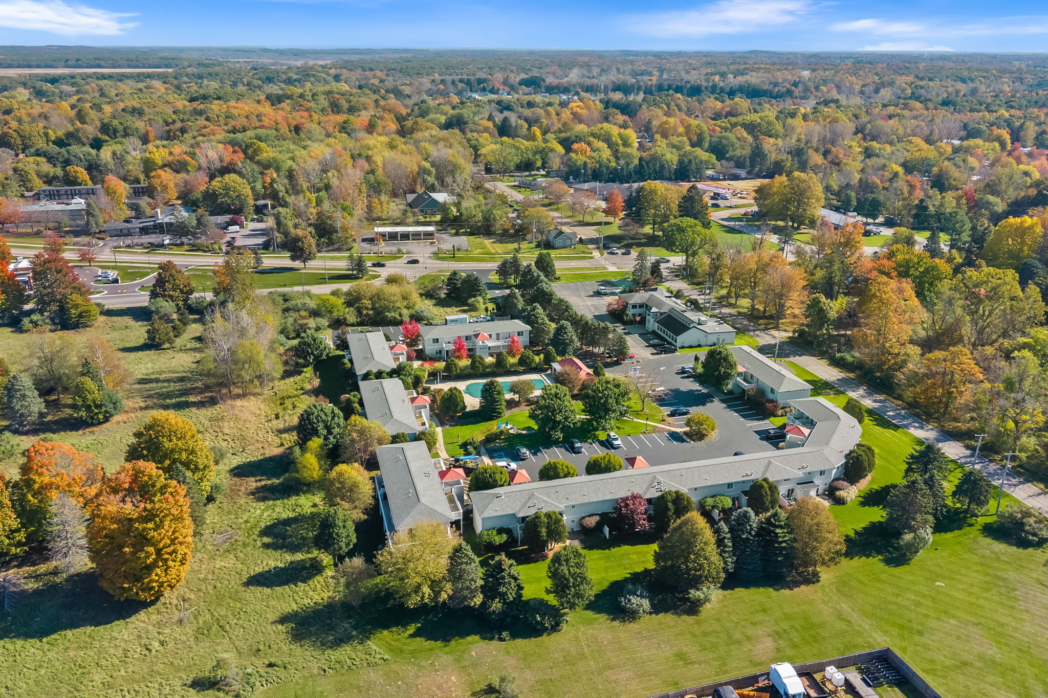Scenic aerial view with lush grounds and colorful fall surroundings
