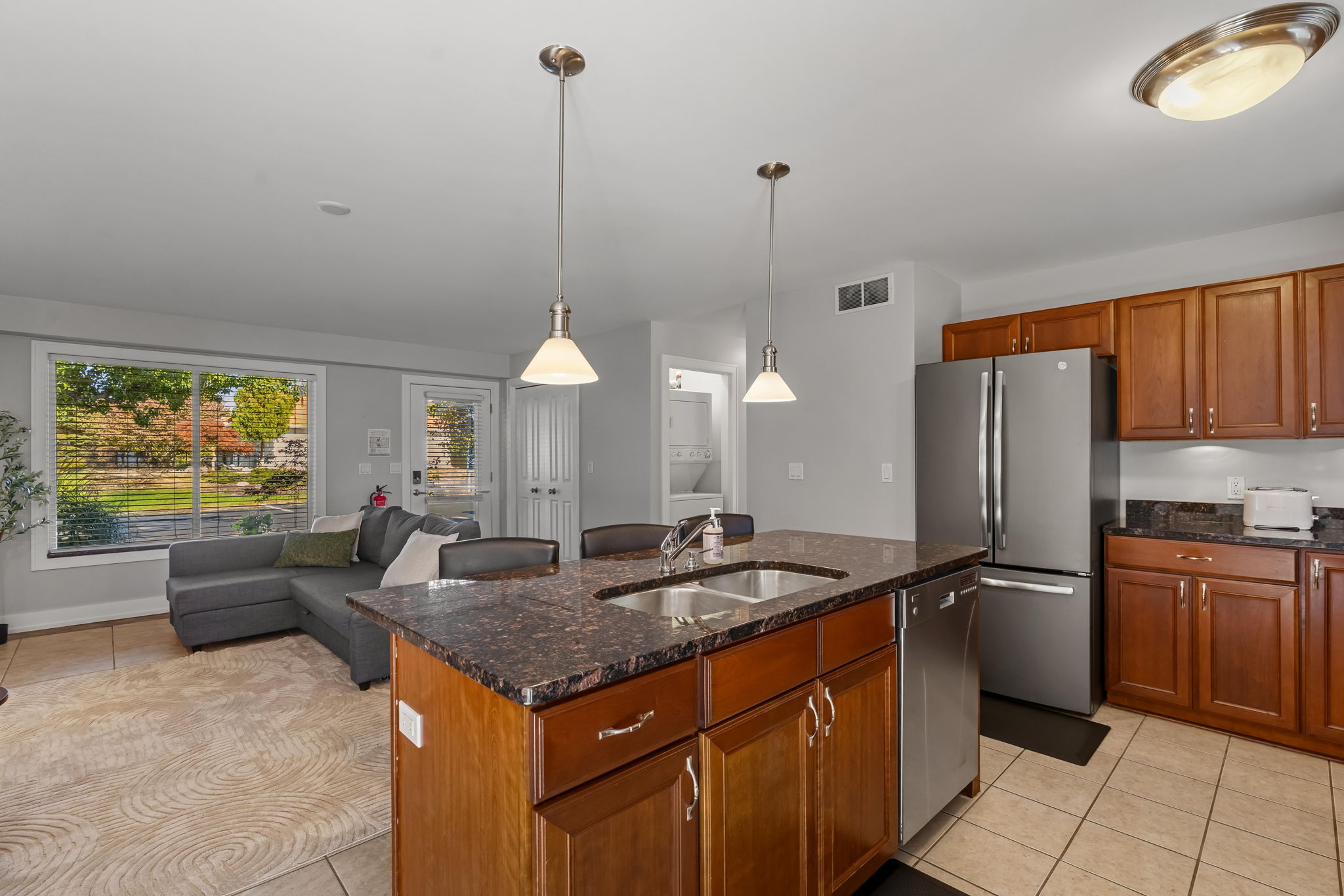 Bright open kitchen with granite island and cozy living area