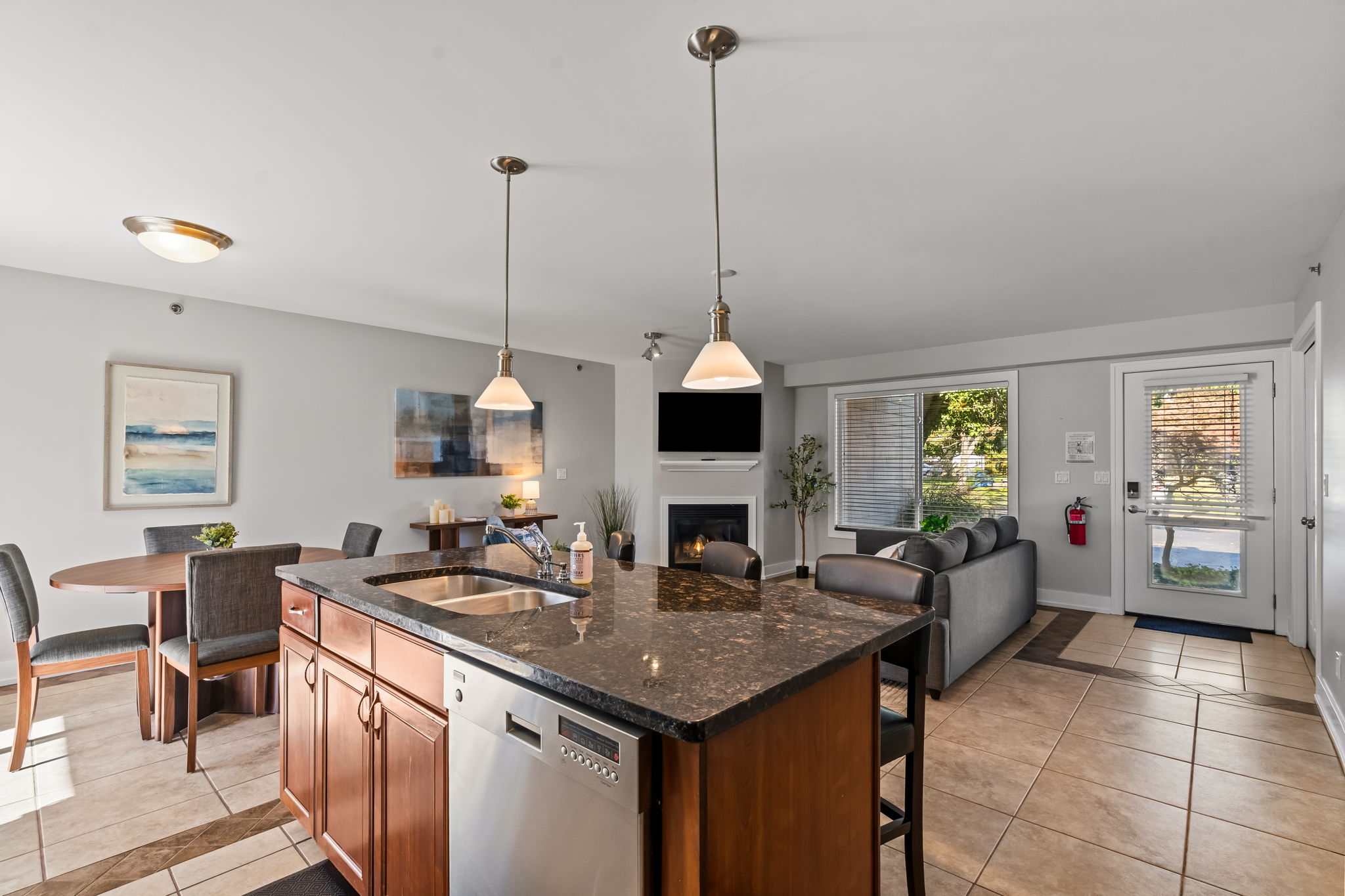 Bright open-concept living with granite island, fireplace, and natural light