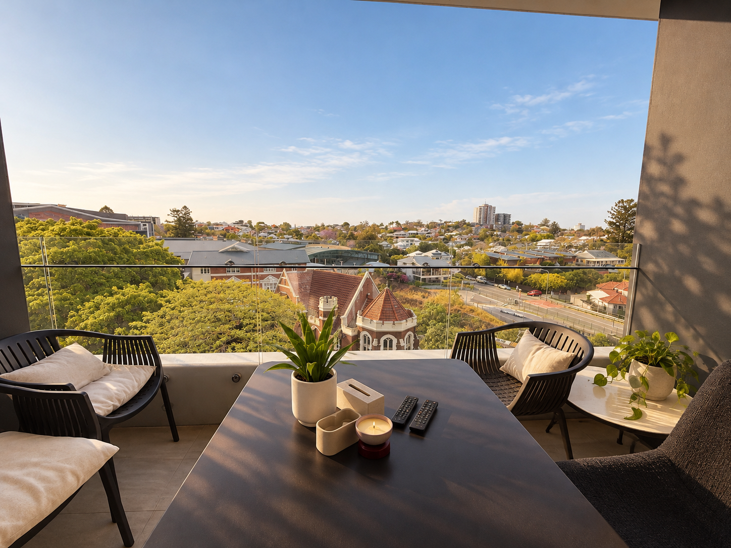 Private balcony with stylish seating and sweeping treetop neighborhood views