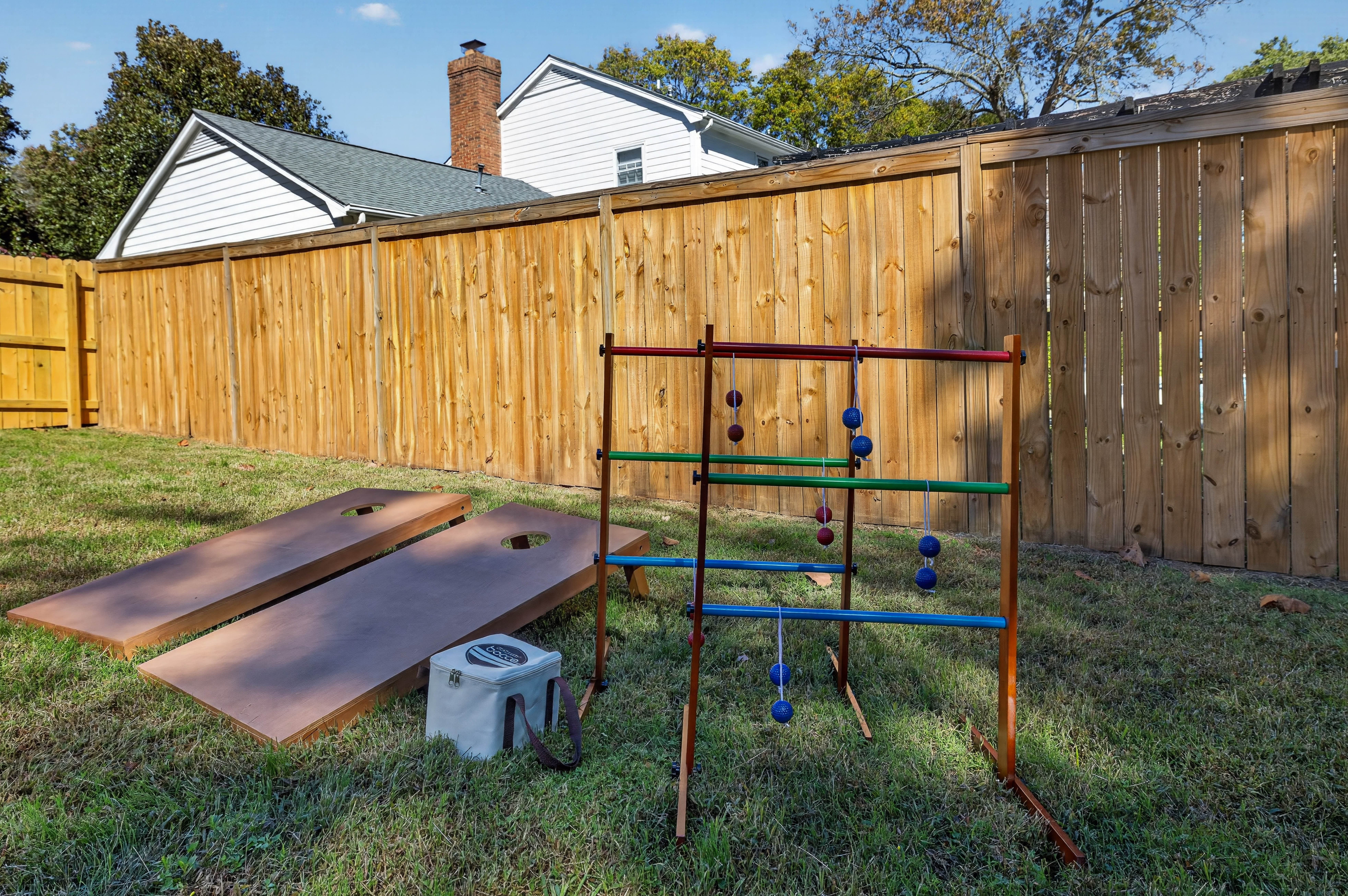Cornhole and ladder toss in the fenced backyard