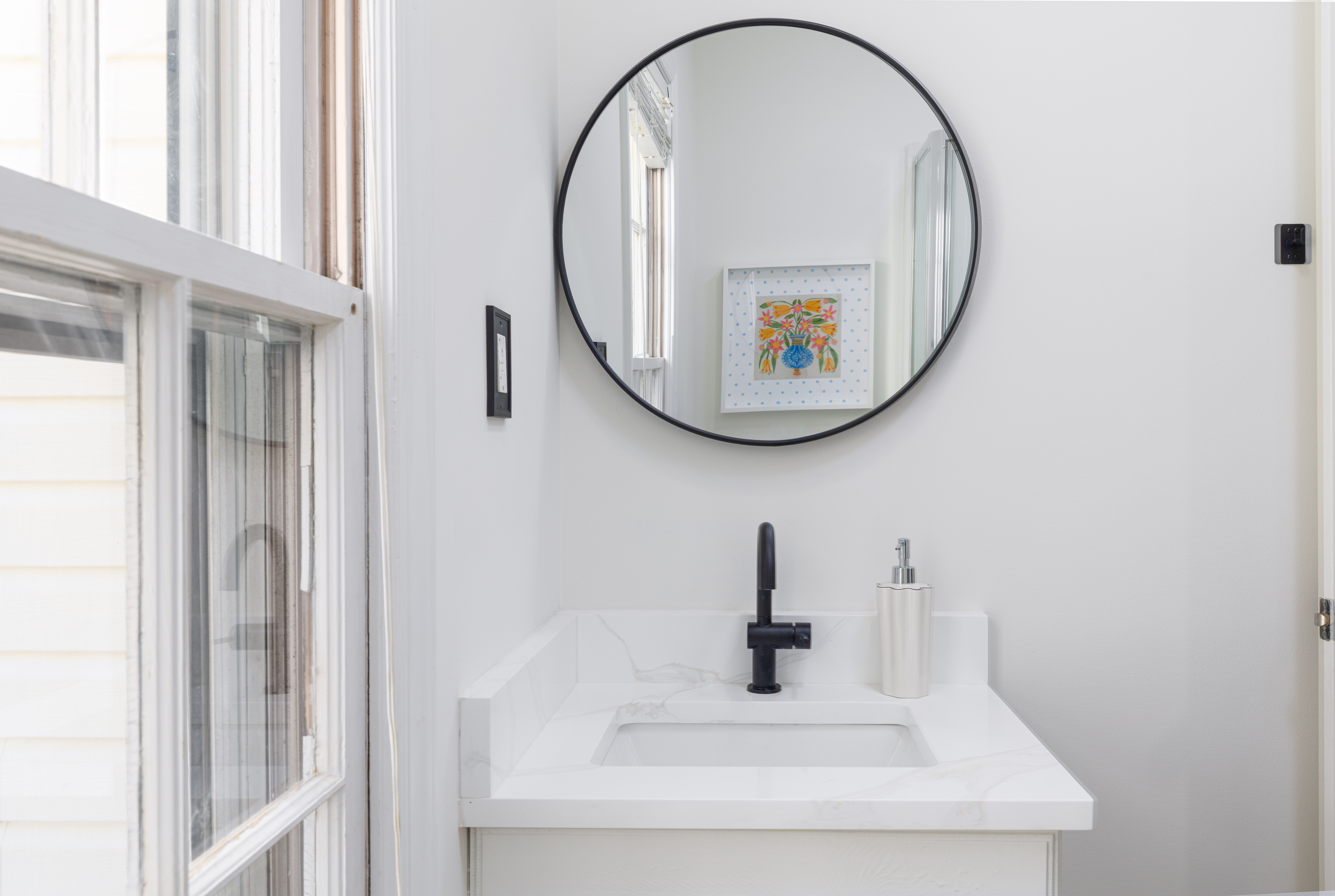 Bathroom vanity with a round mirror