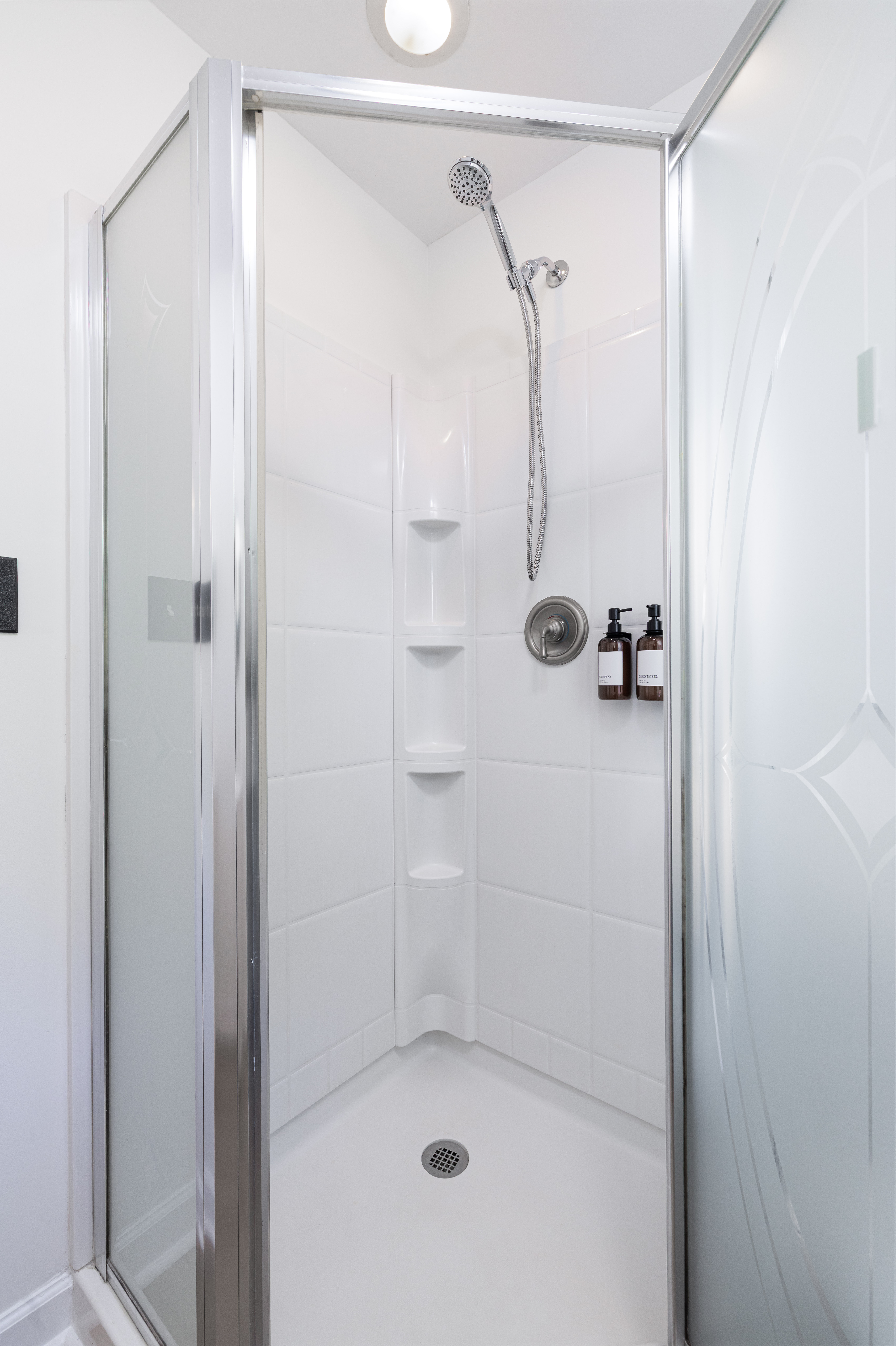 Downstairs full bath with a walk-in shower