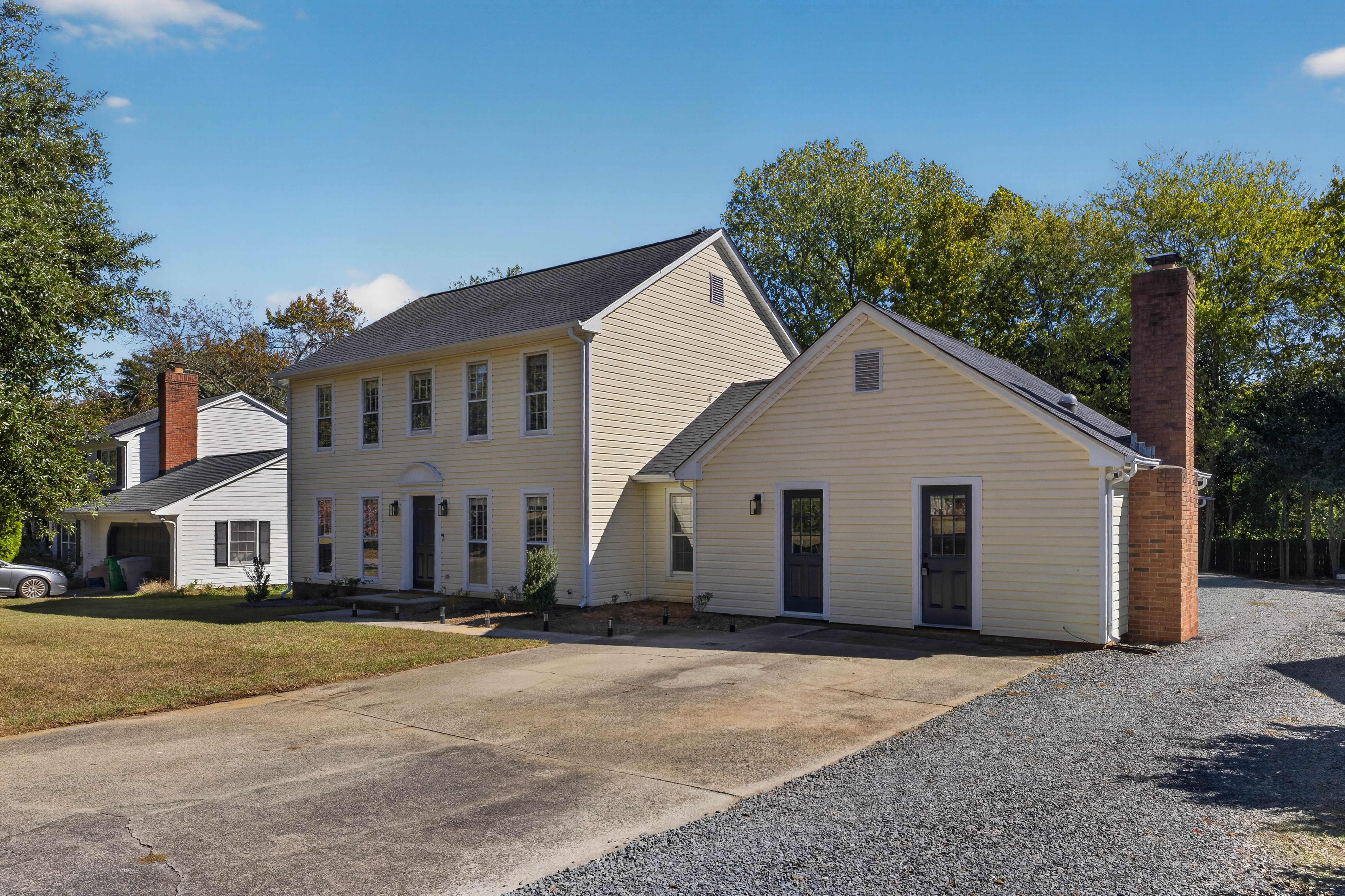 The Main House from the street, with paved parking out front