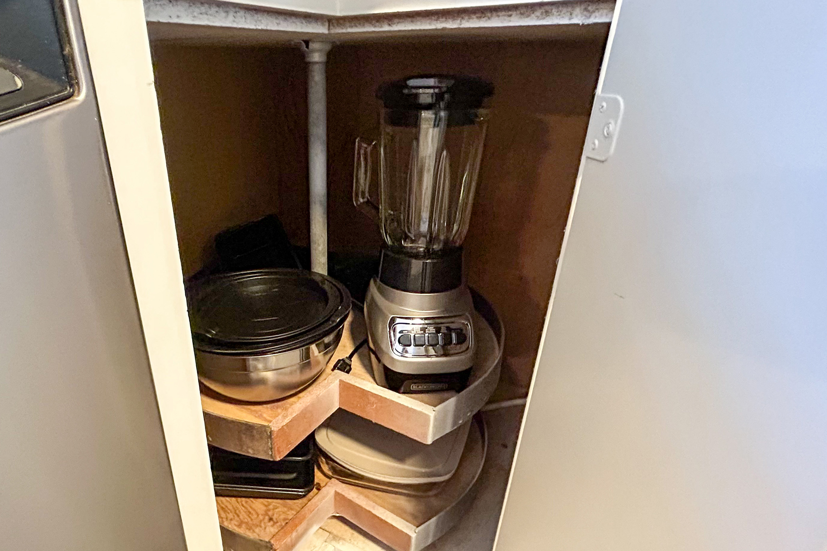 Corner cabinet with a blender and extra cookware