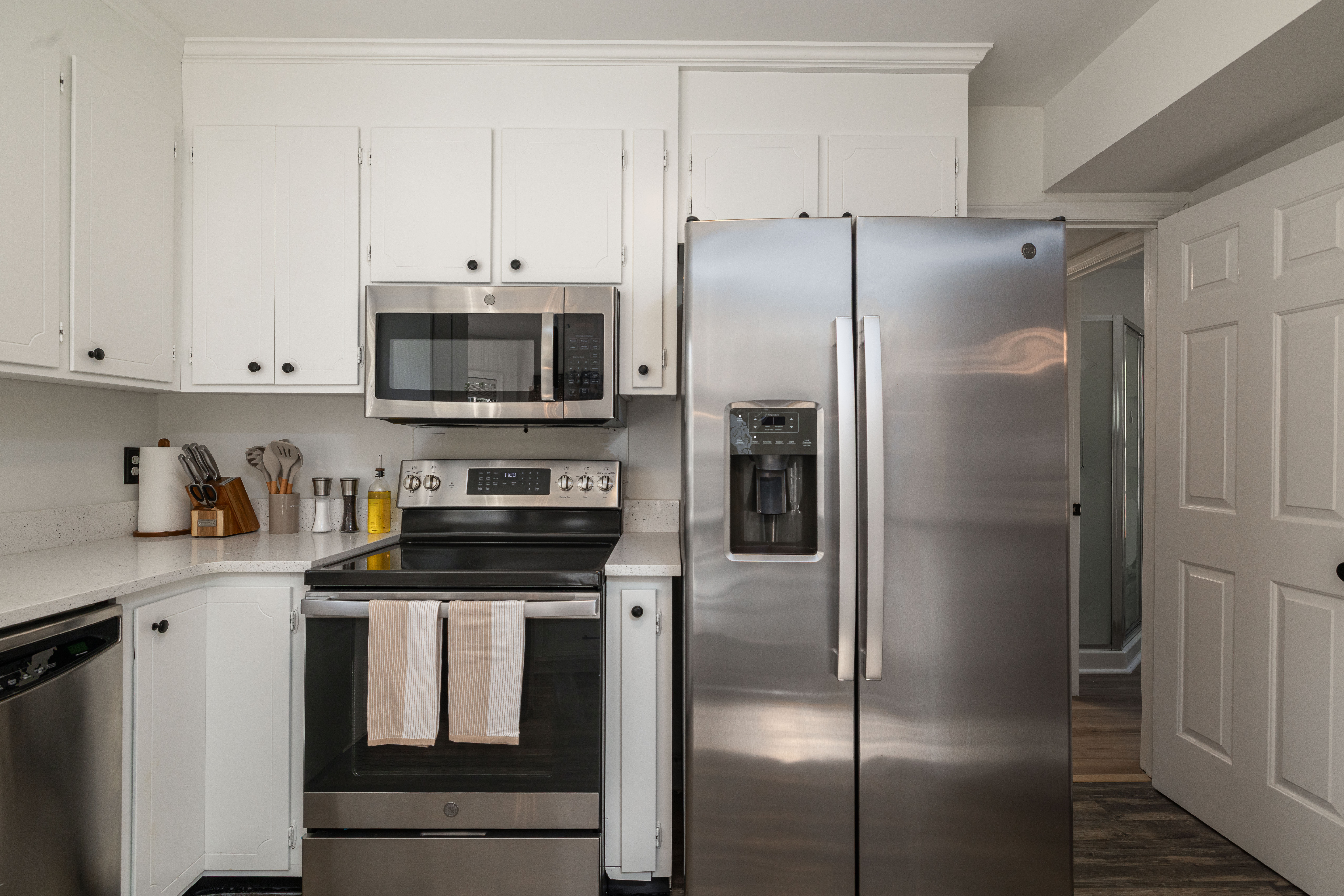 Kitchen with a full-size fridge, electric range and microwave