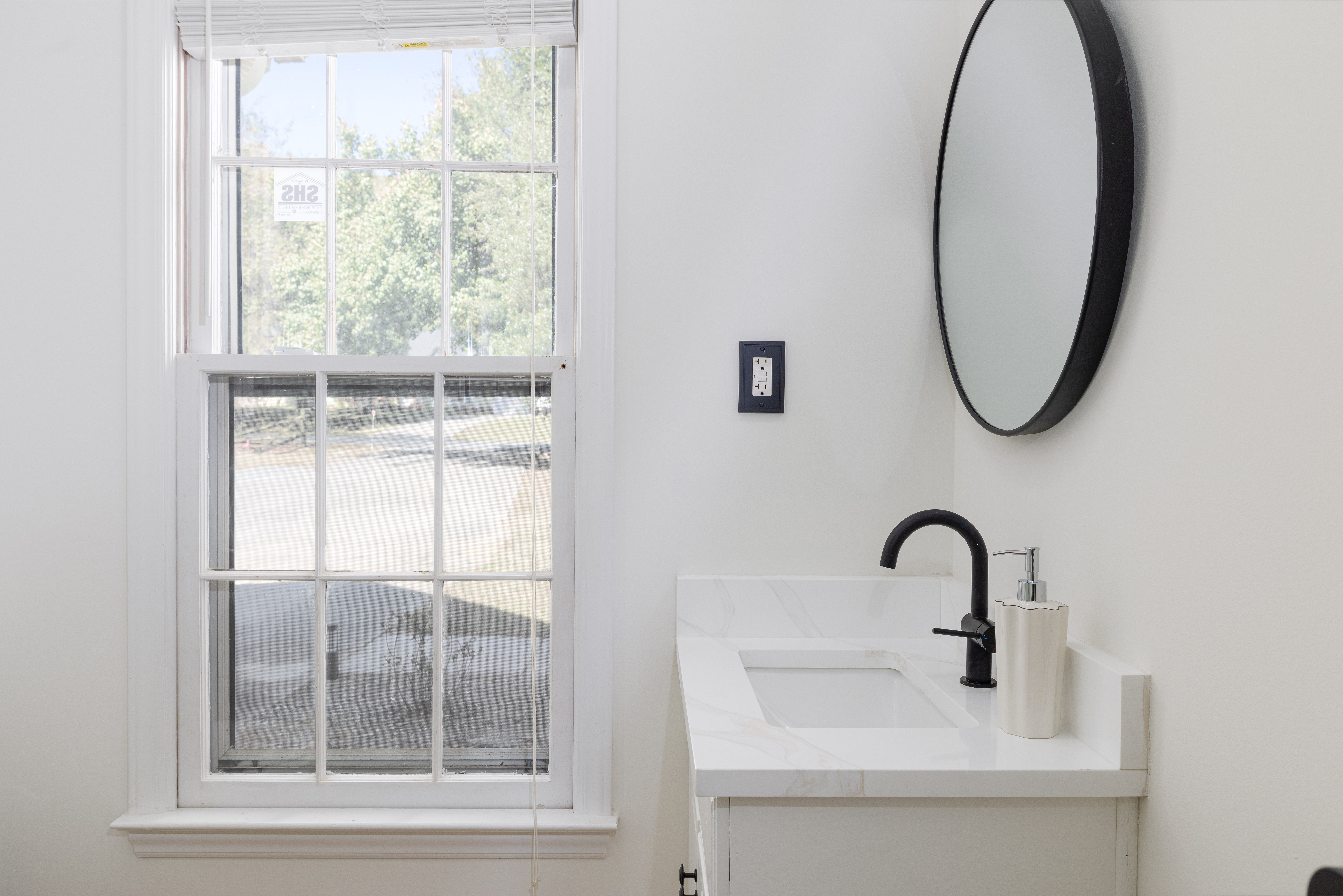 Bathroom vanity beside a window