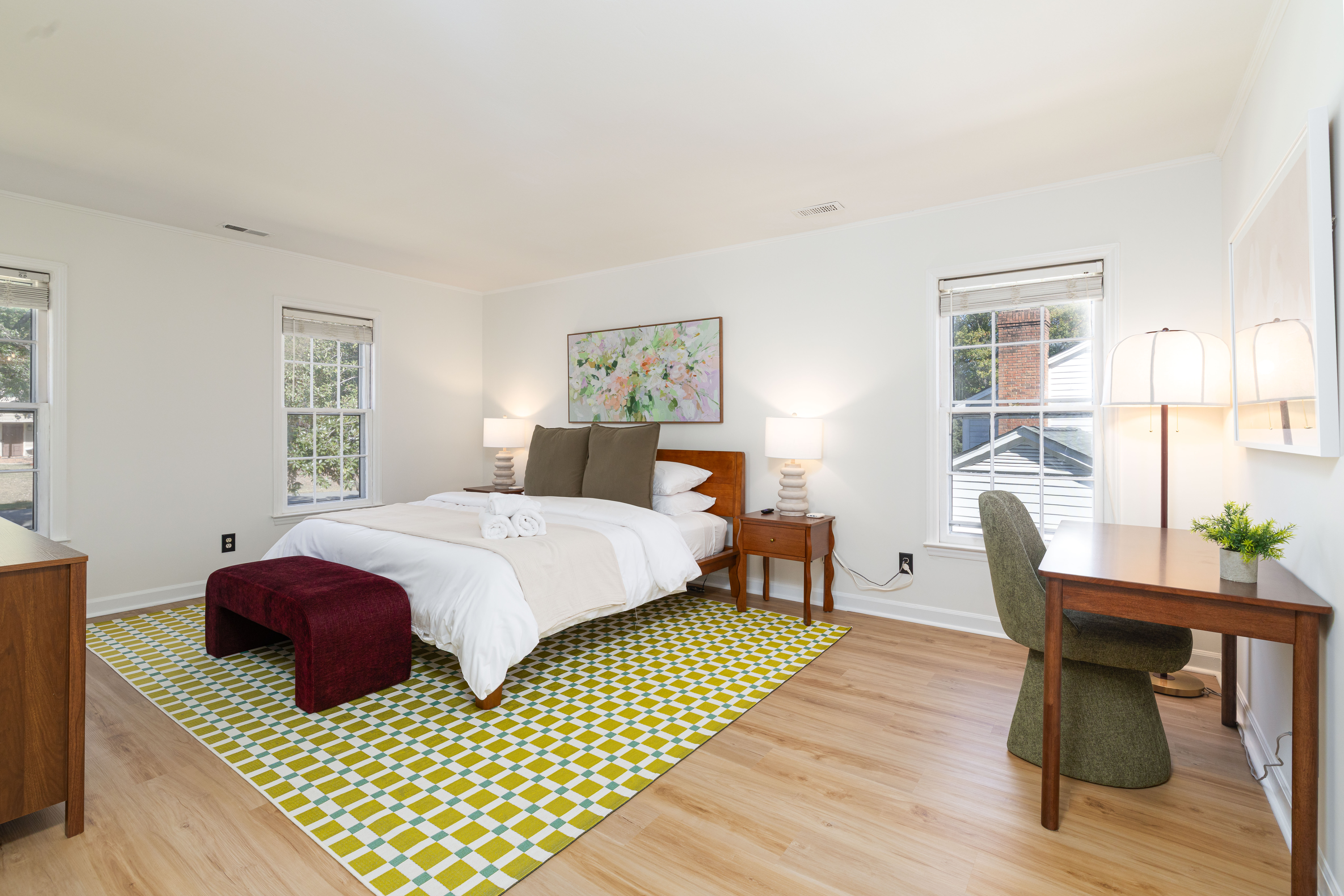 Primary suite: king bed, bench and desk