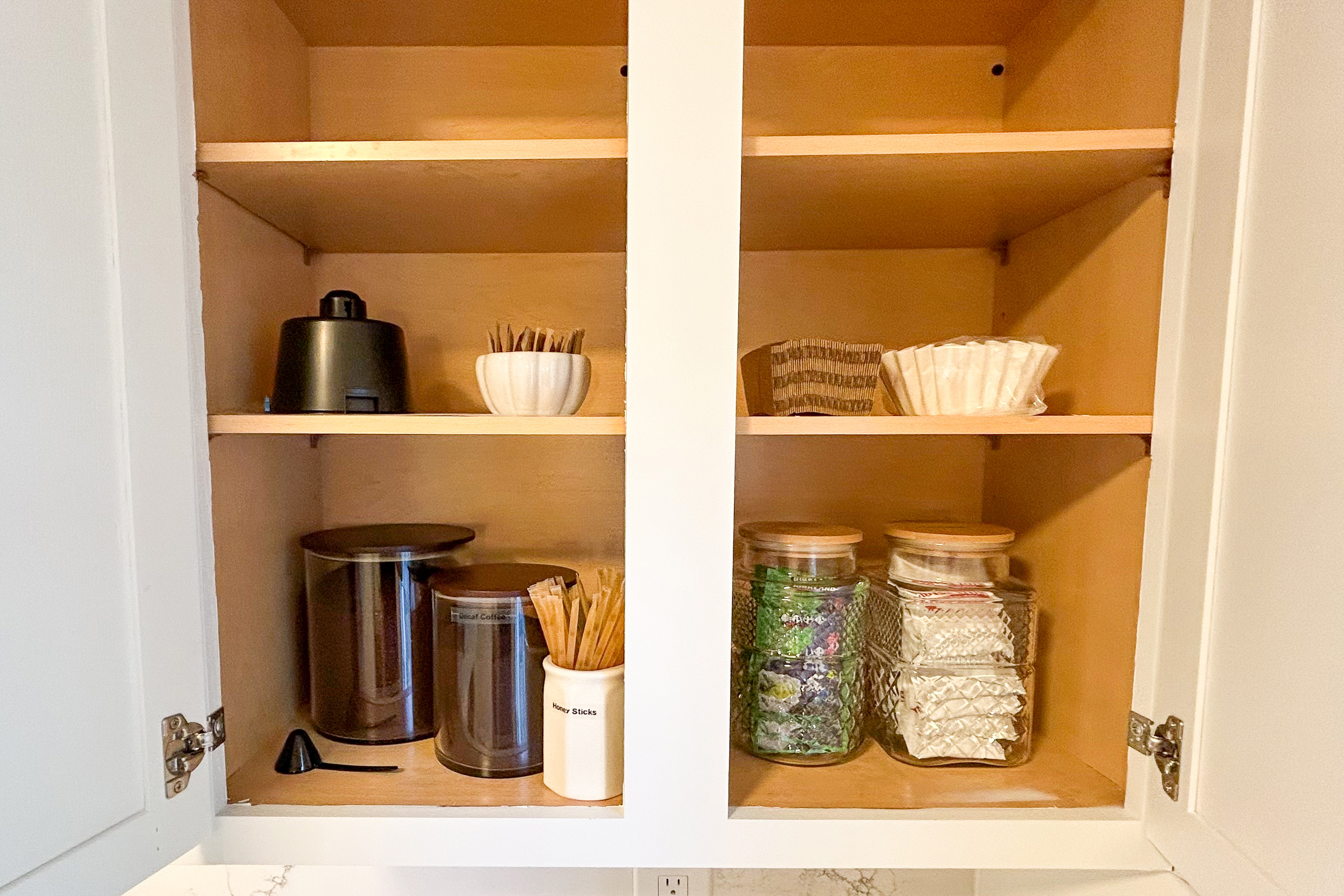 Coffee bar cabinet with coffee, filters, tea and honey sticks