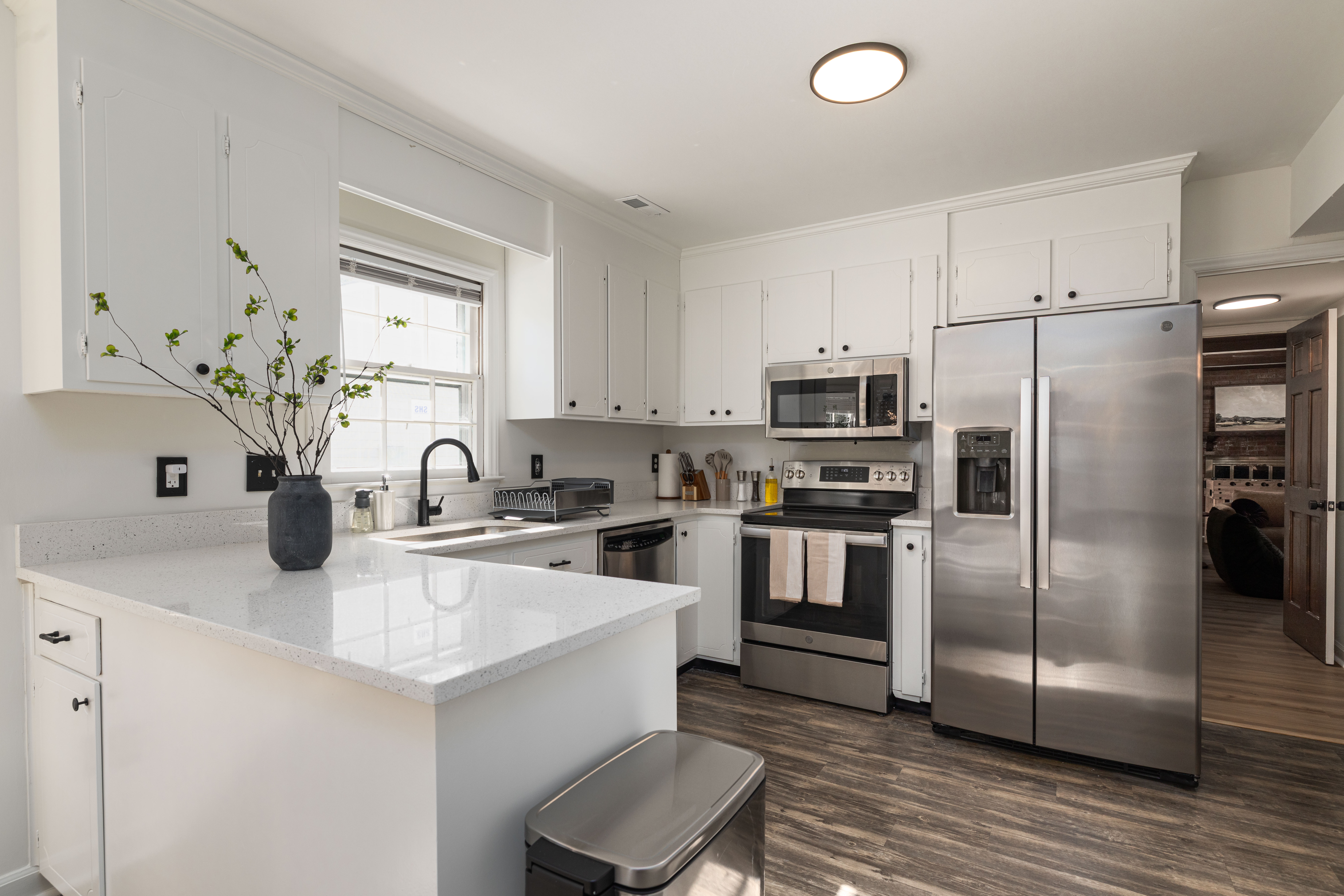 Full kitchen with a full-size fridge, electric range, microwave and island