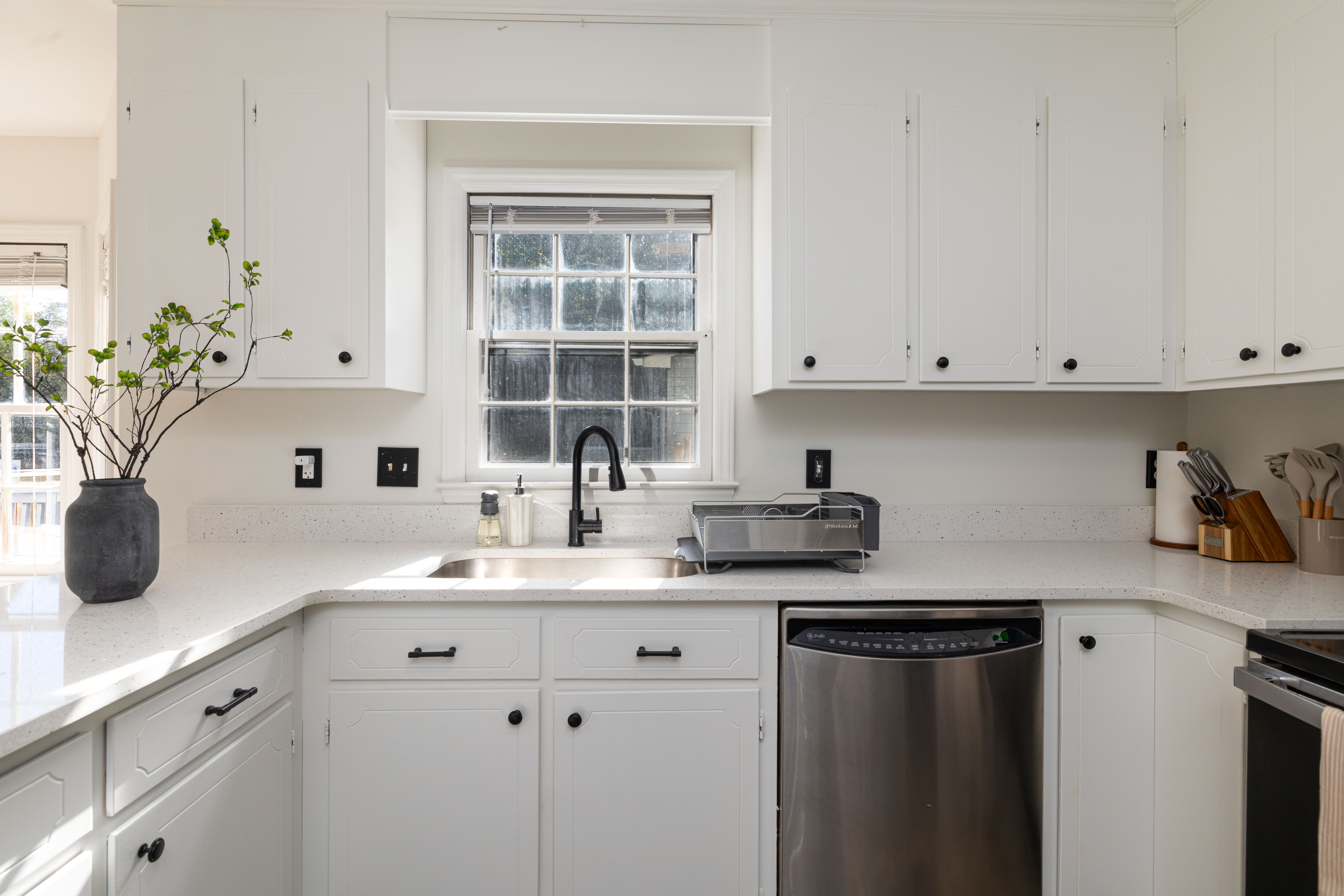 Kitchen sink under the window, beside the dishwasher