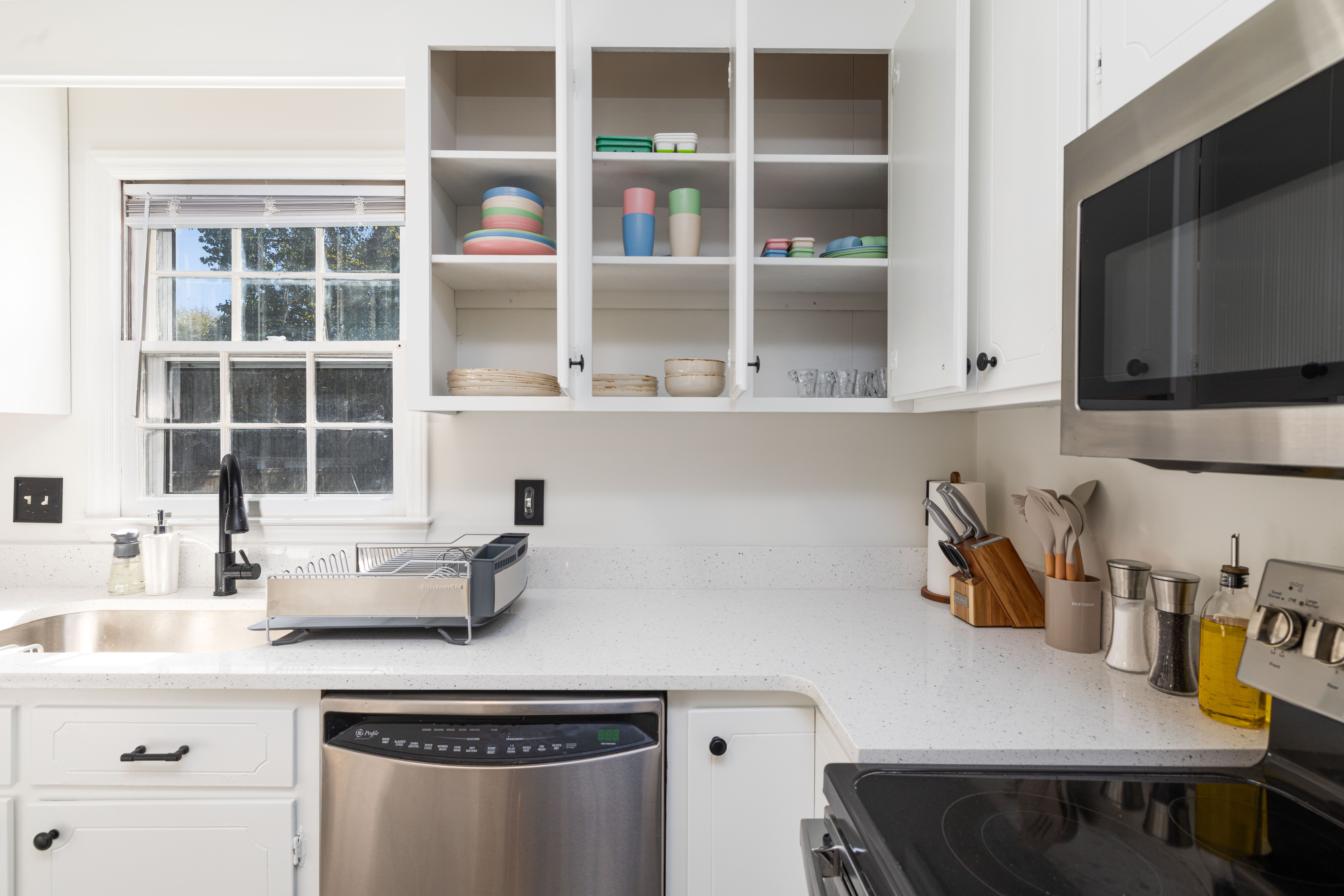 Kitchen counter with the dishwasher, toaster, microwave and electric range