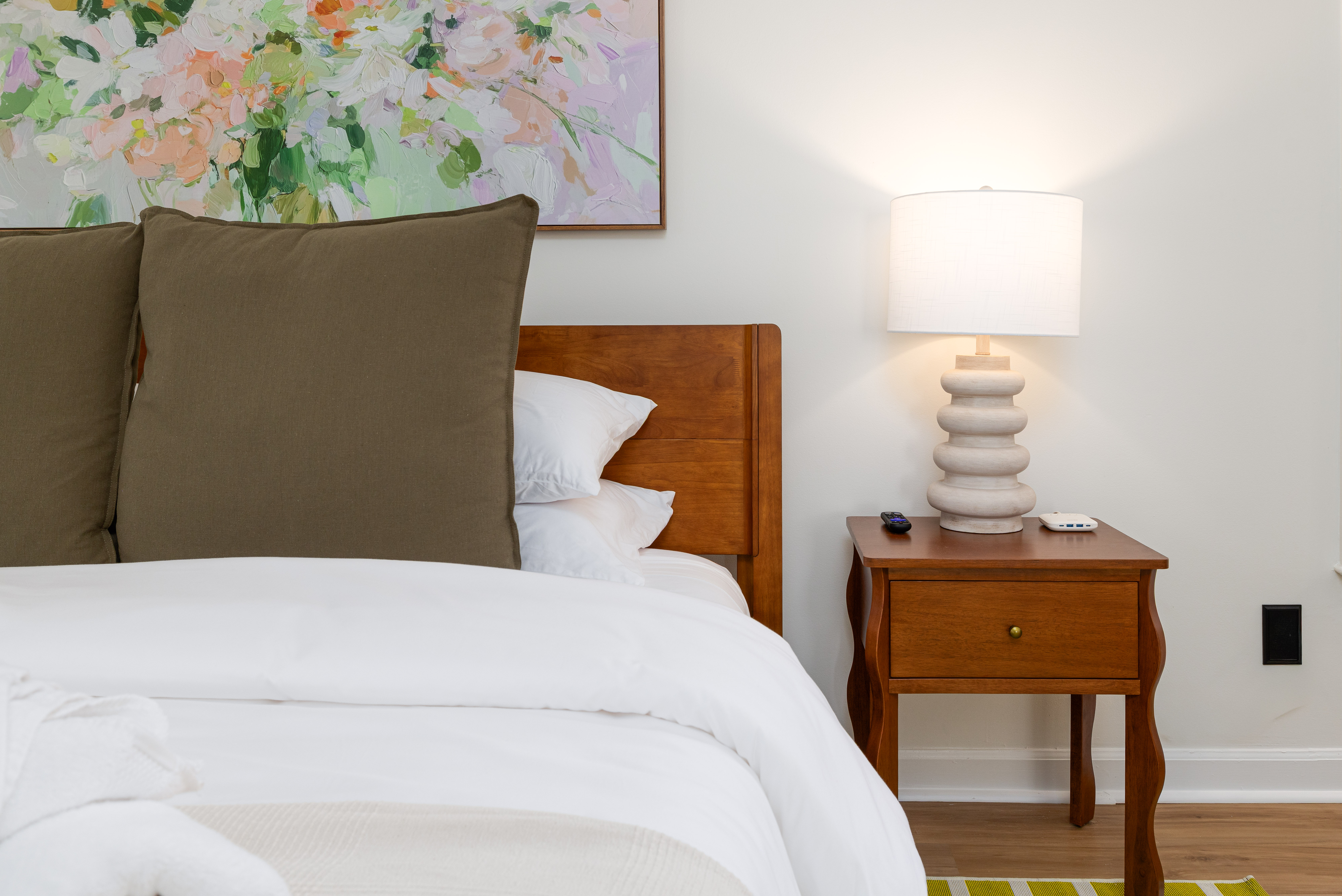 Primary king bed with a nightstand and lamp
