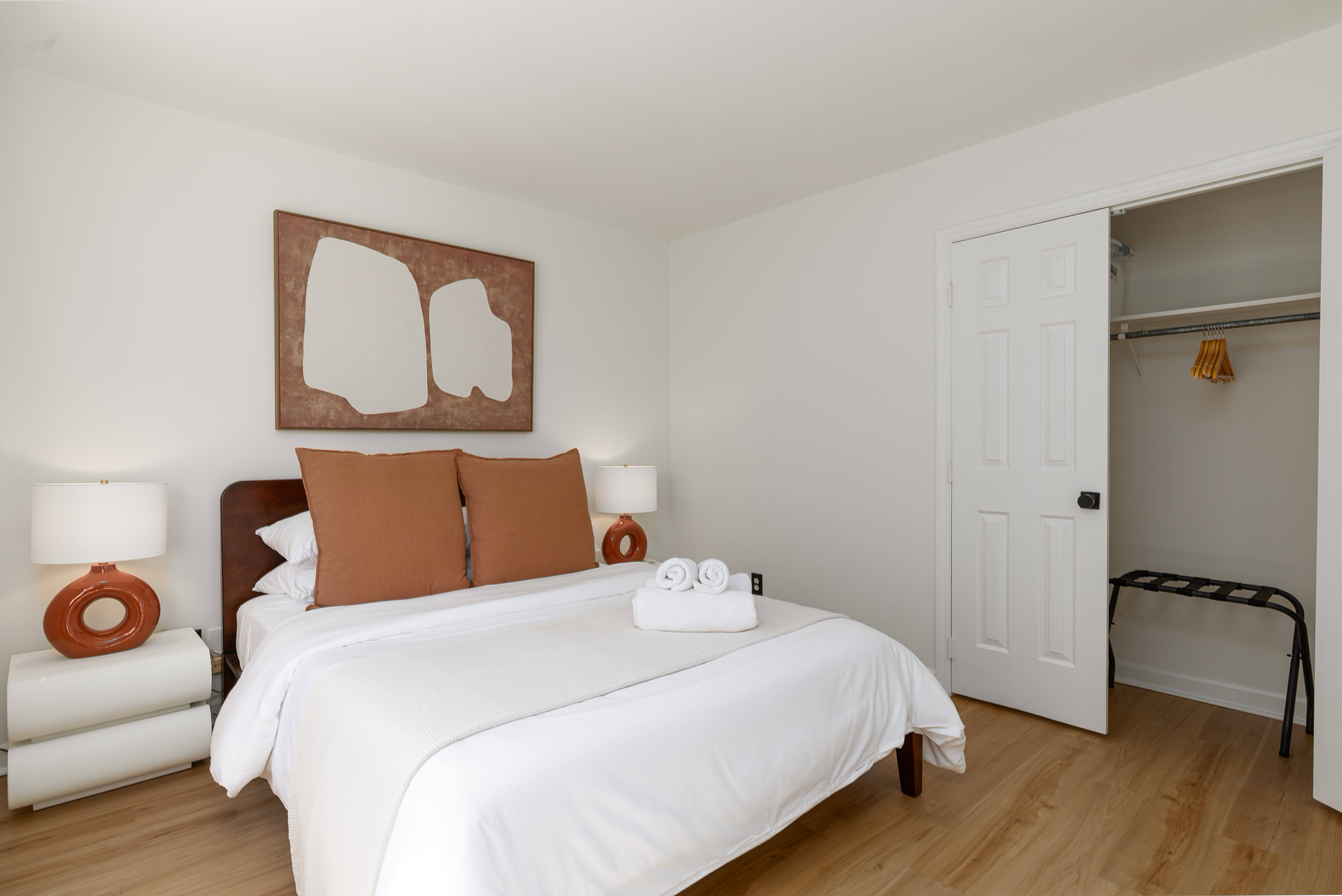 Bedroom 2: queen bed and a closet with a luggage rack