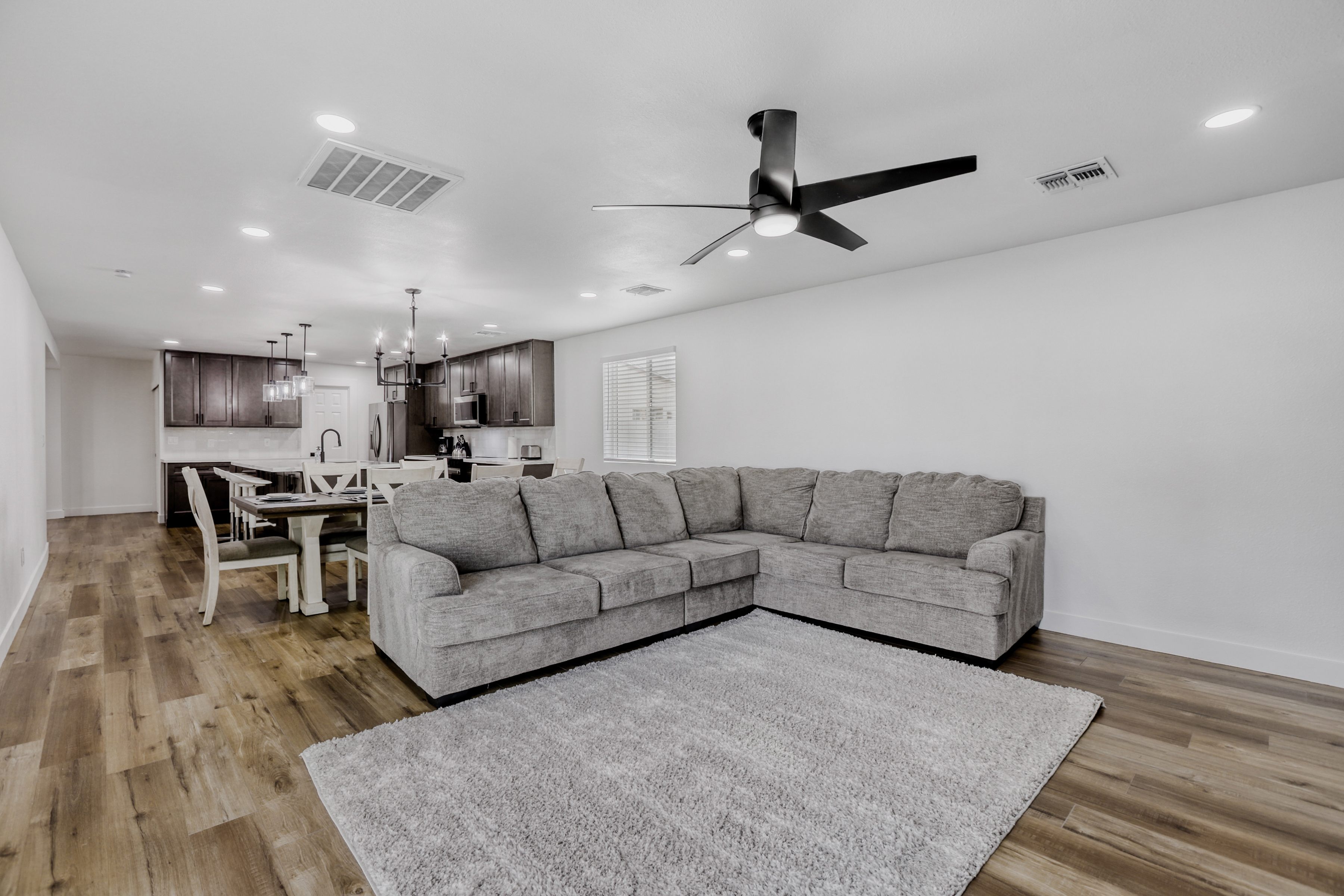 Spacious open living area with large sectional and modern kitchen