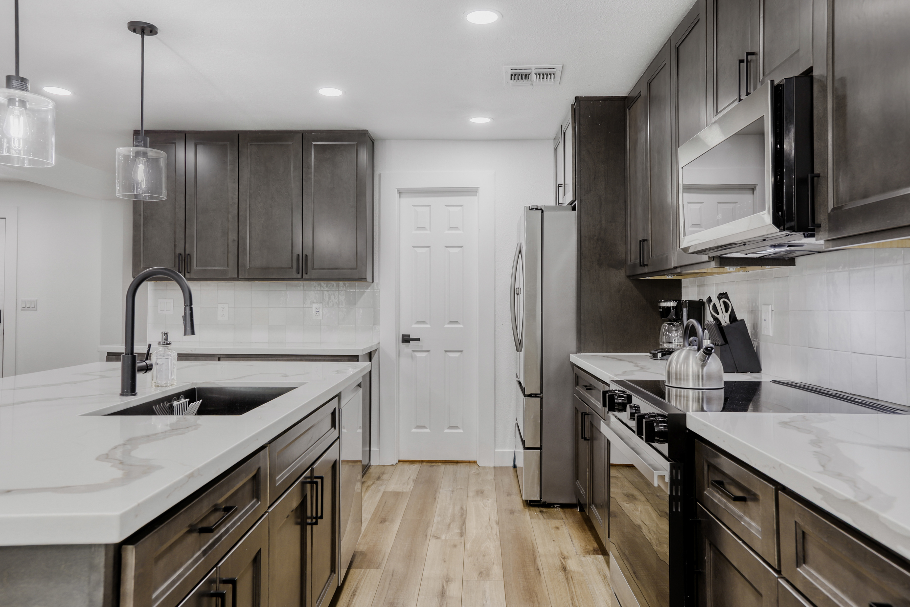 Modern chef’s kitchen with quartz counters, island seating, and sleek finishes