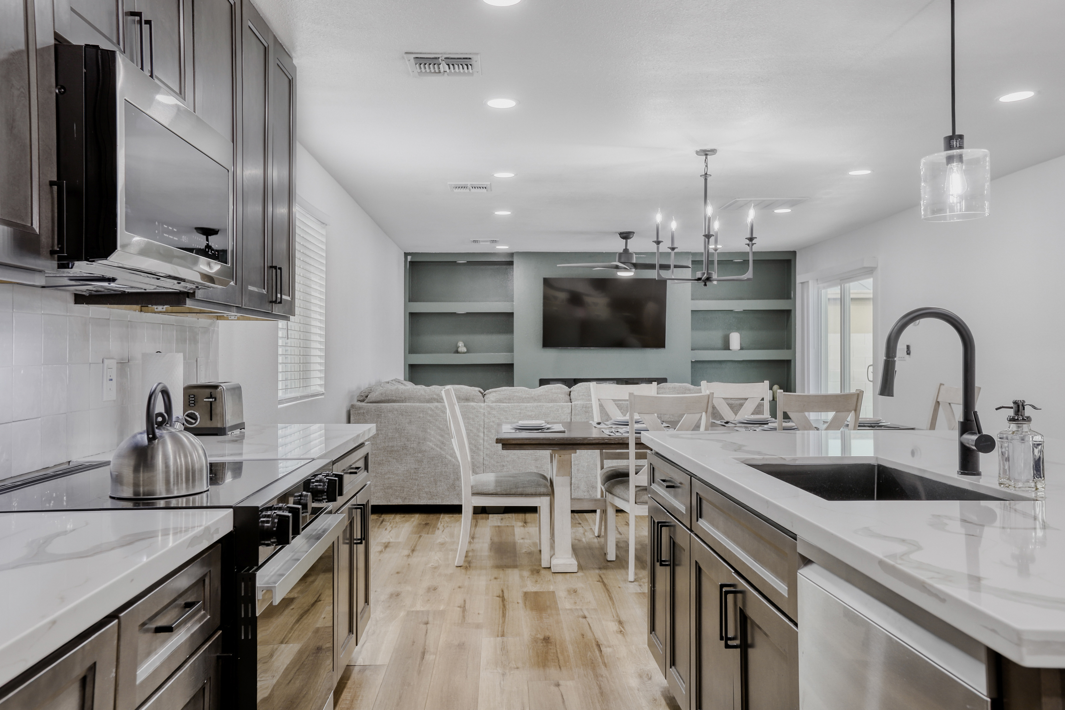 Bright open kitchen with quartz island and seamless dining-living flow