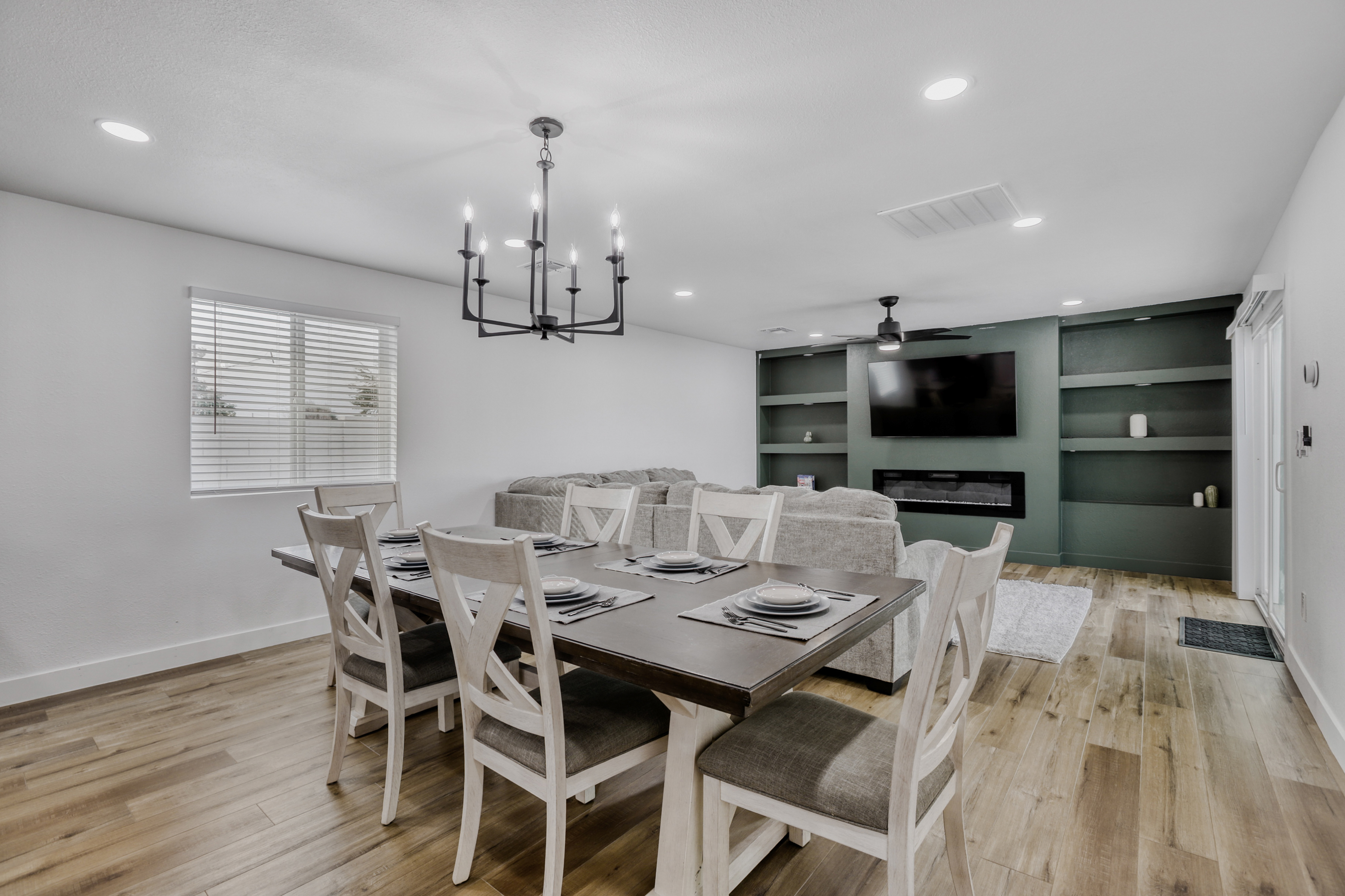 Open dining and living space with fireplace, TV, and seating for six