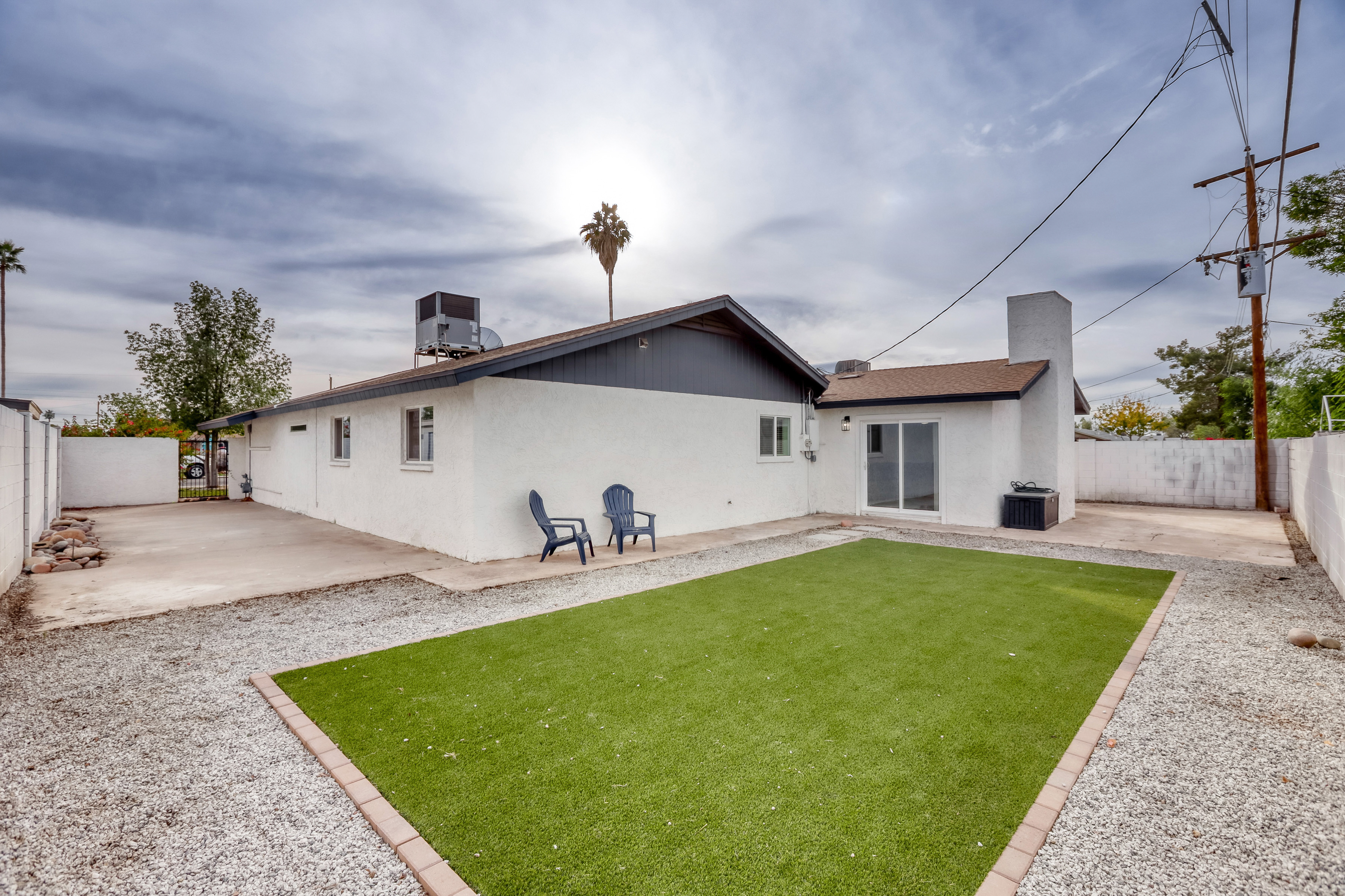 Spacious fenced backyard with turf lawn and easy indoor-outdoor access