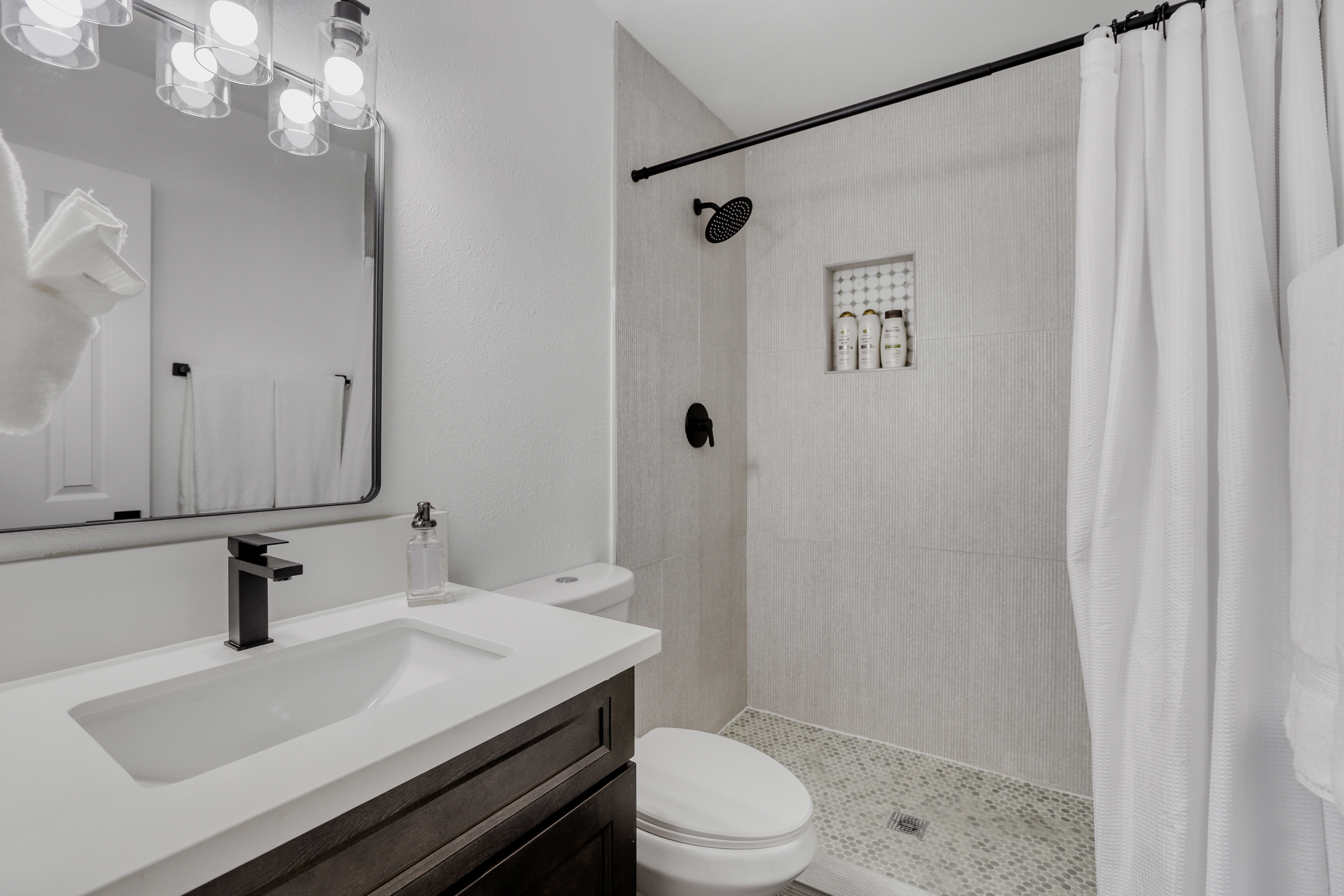 Bright modern bath with walk-in shower and sleek spa-like finishes