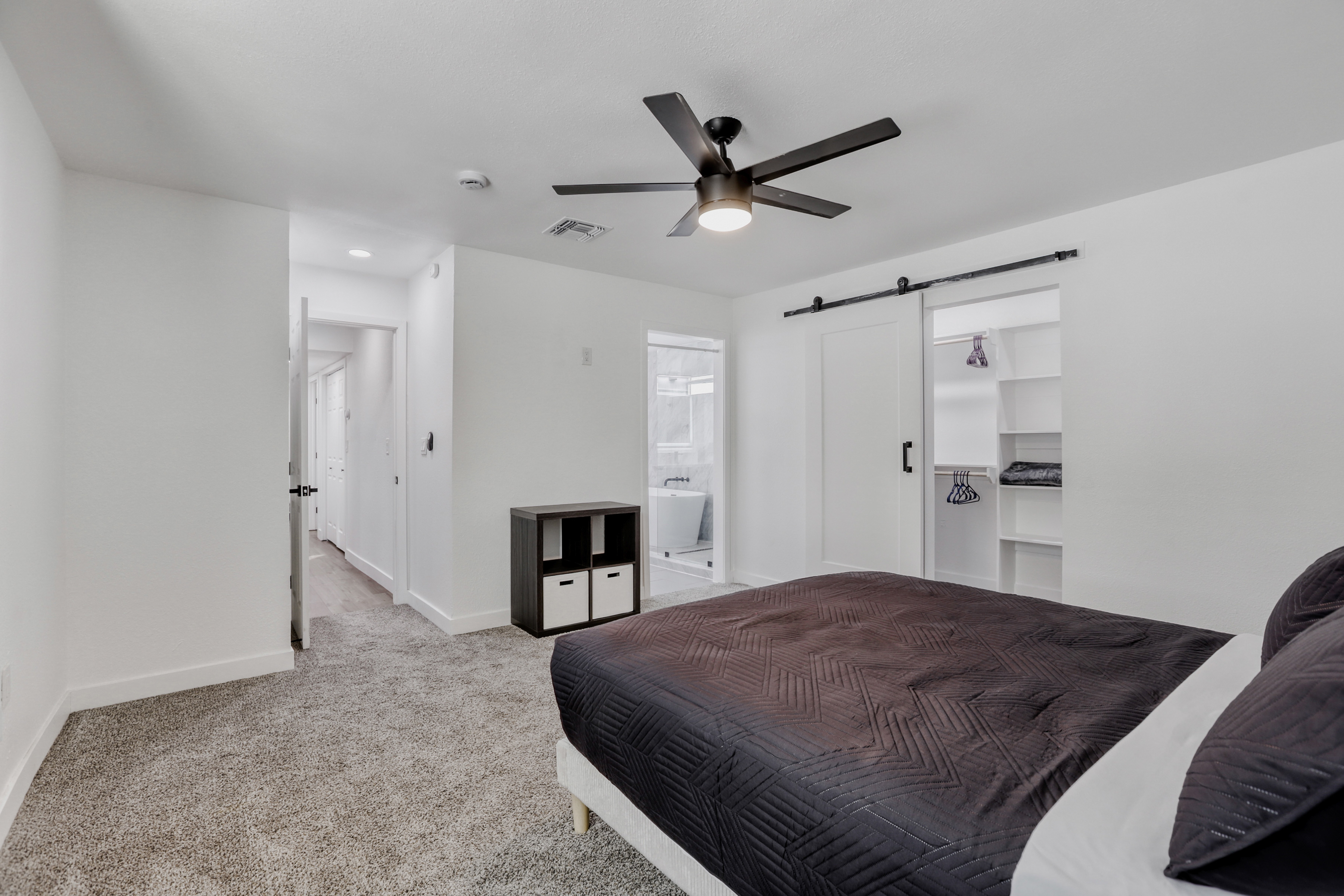 Bright, spacious bedroom with barn-door closet and en suite bath