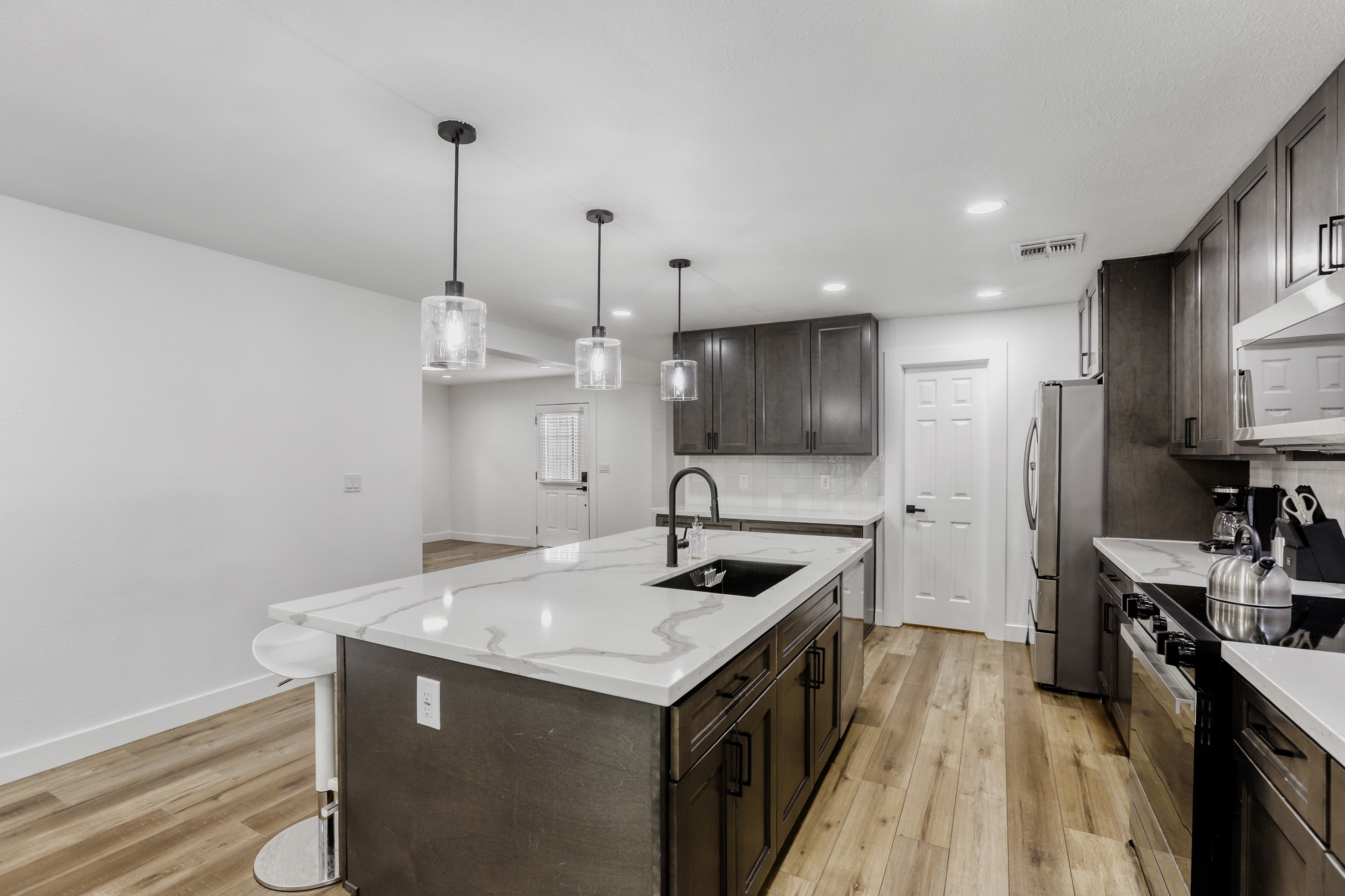 Modern chef’s kitchen with waterfall island and sleek finishes