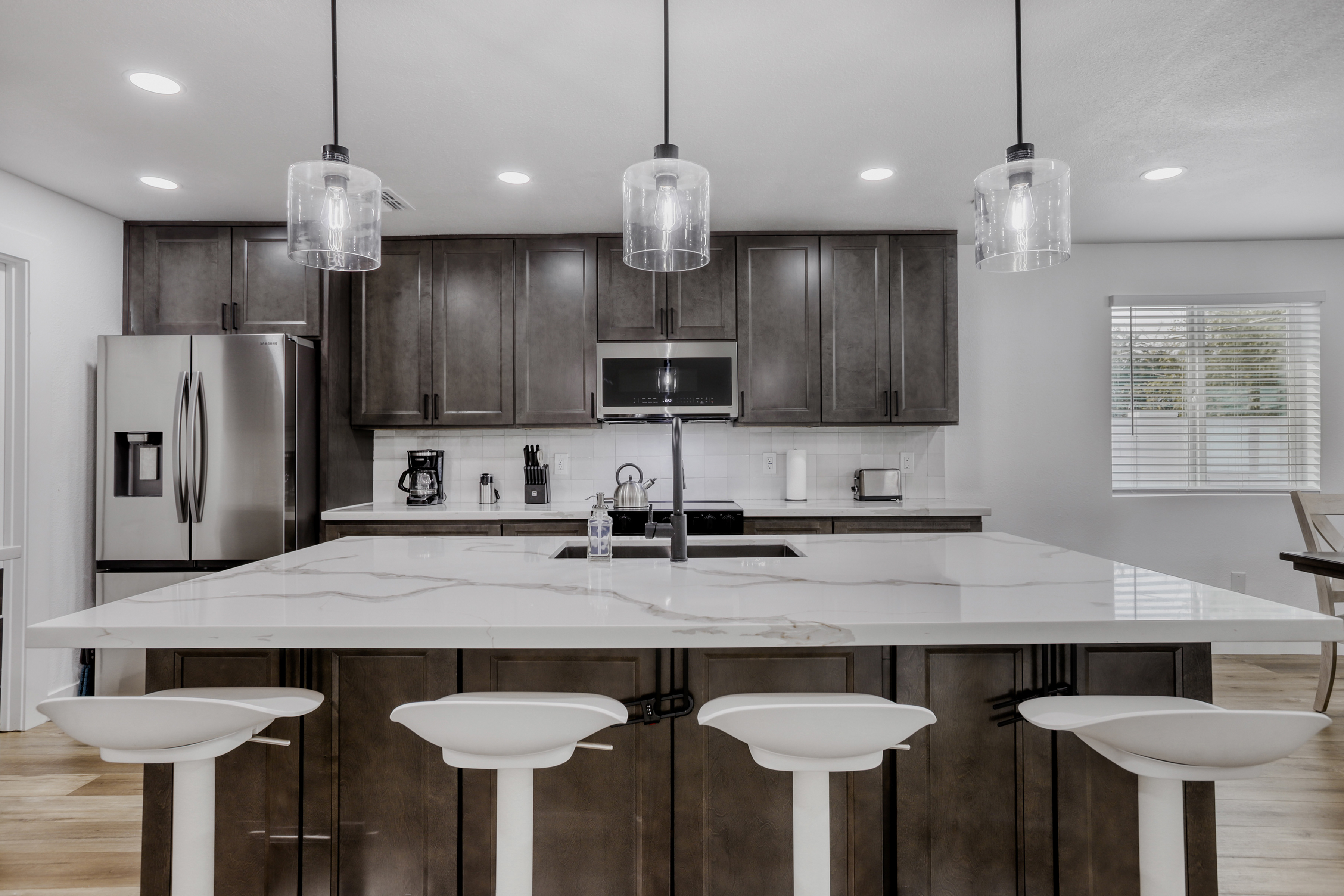 Spacious modern kitchen with oversized island and seating for four