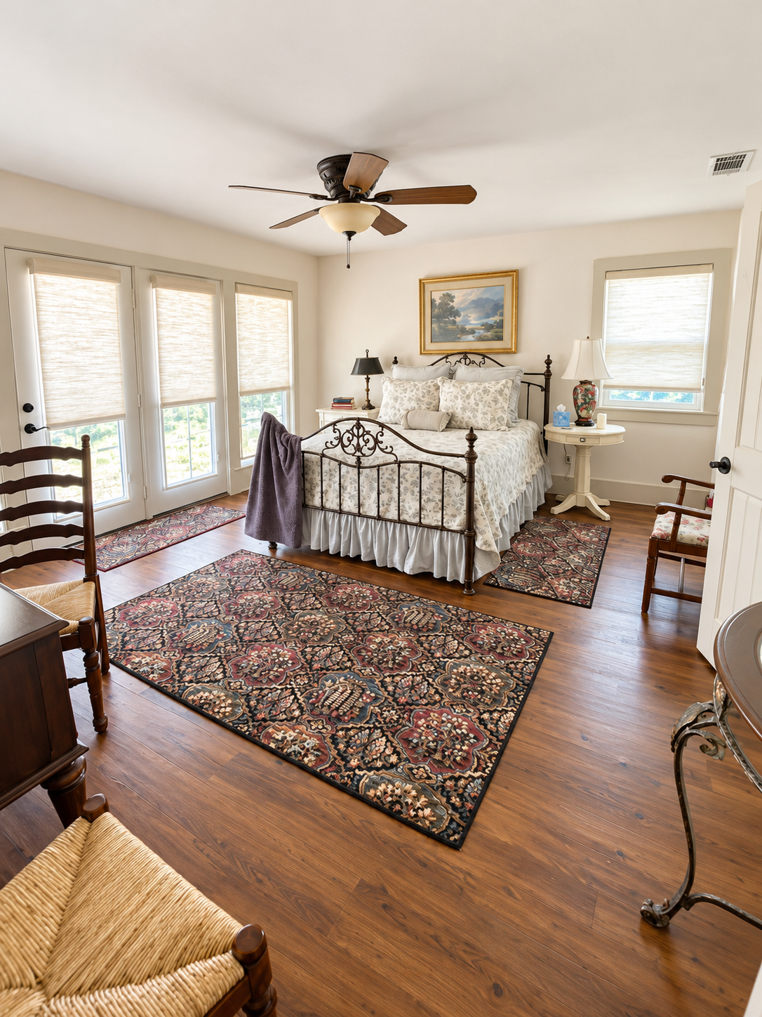 Bright, elegant bedroom with French doors, vintage charm, and cozy details