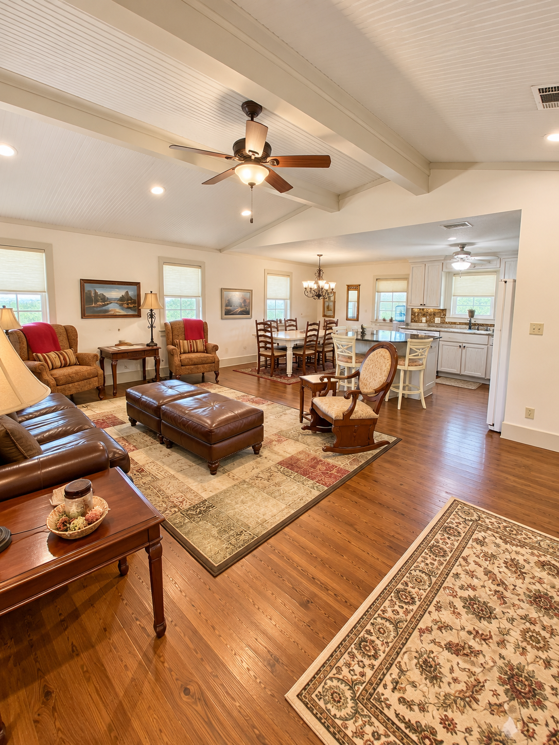 Spacious open living area with vaulted ceilings, dining space, and bright kitchen