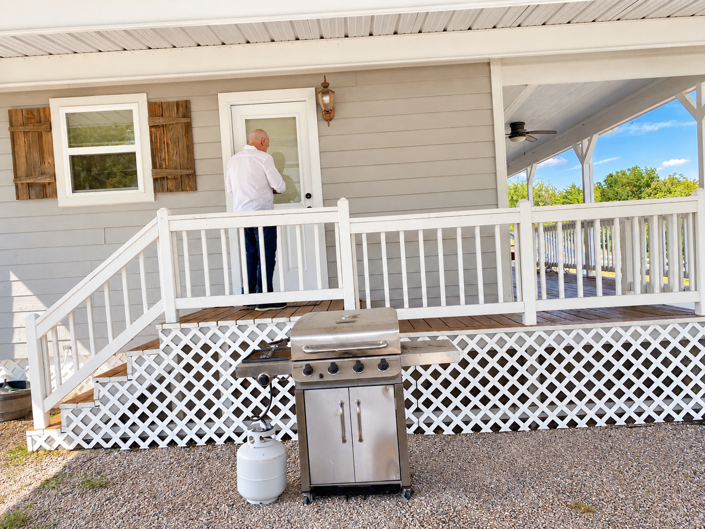 Covered porch with grill and plenty of space to relax outdoors