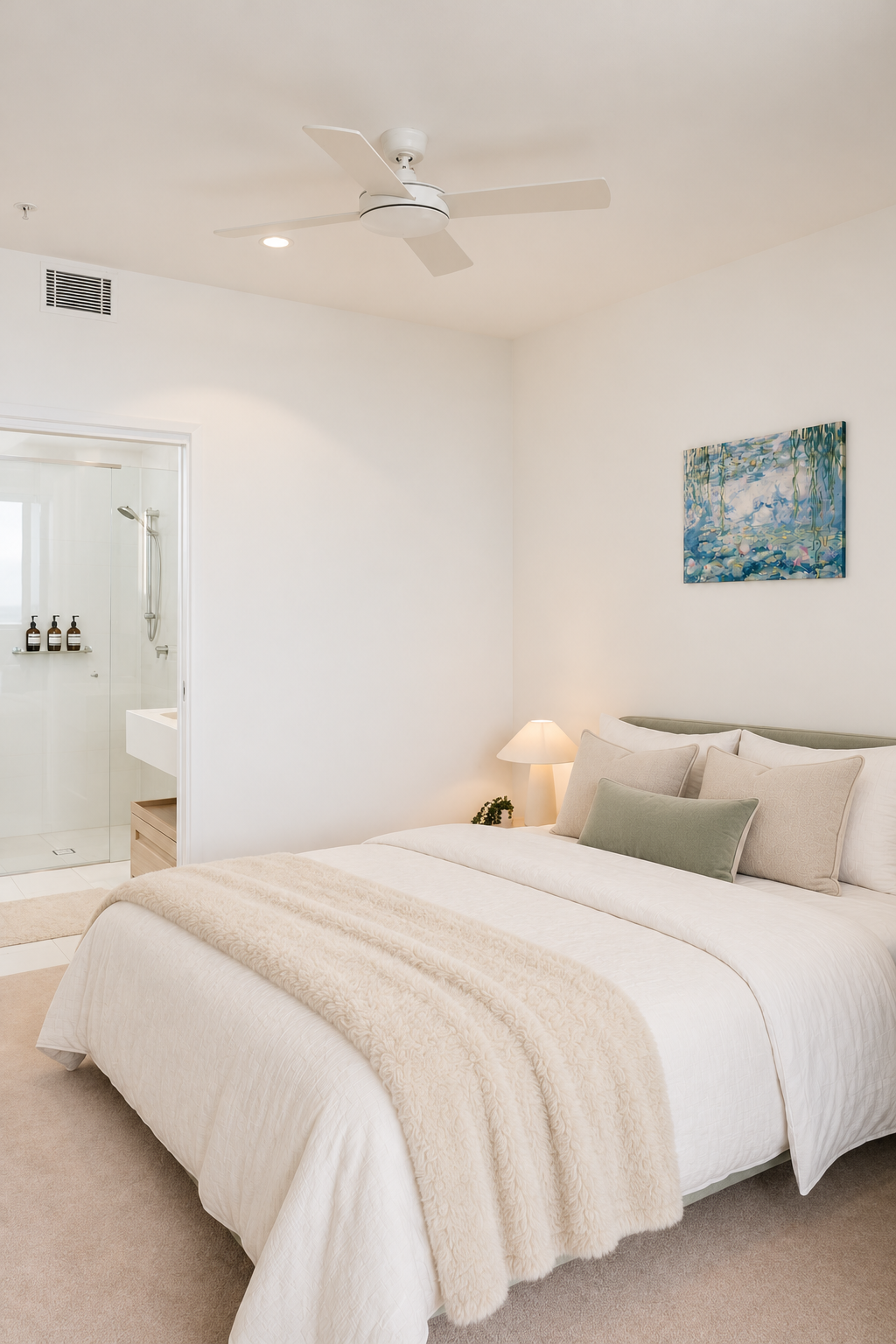 Serene ensuite bedroom with plush bedding and bright, modern design