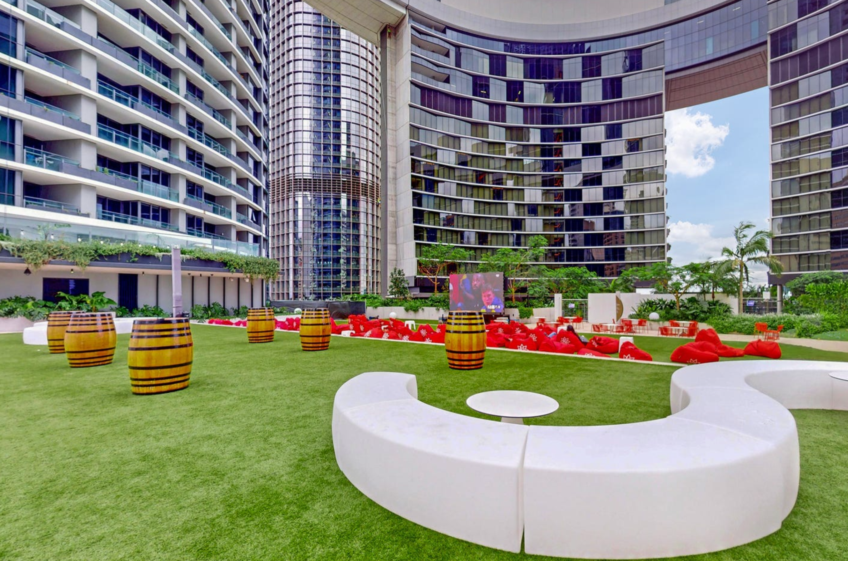 Modern outdoor lounge with landscaped lawn in a sleek high-rise setting