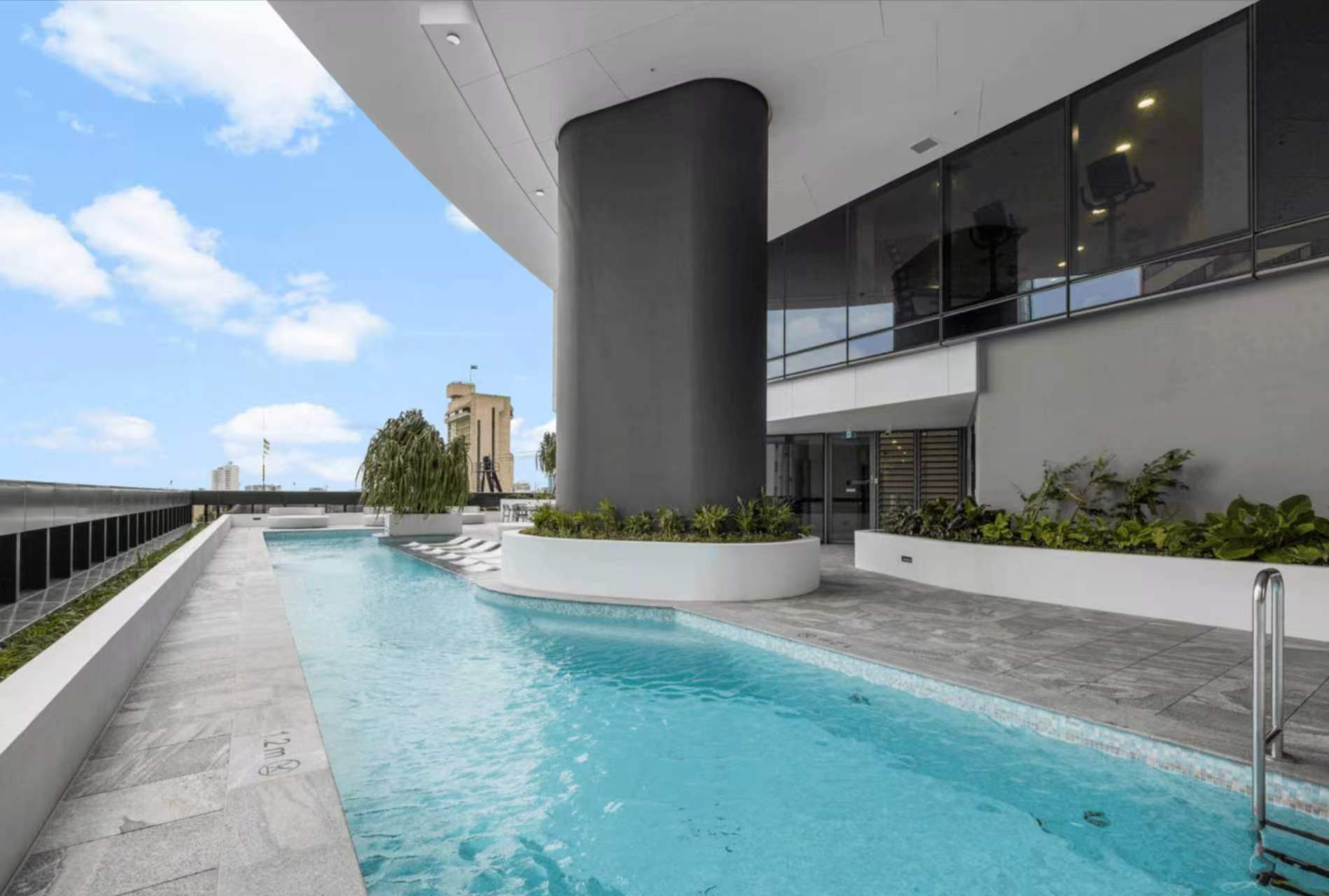 Modern lap pool with sleek design and relaxing open-air deck