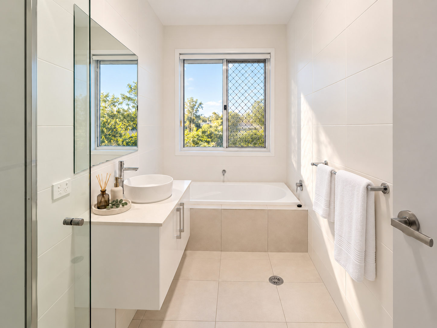 Bright modern bathroom with soaking tub and leafy natural views