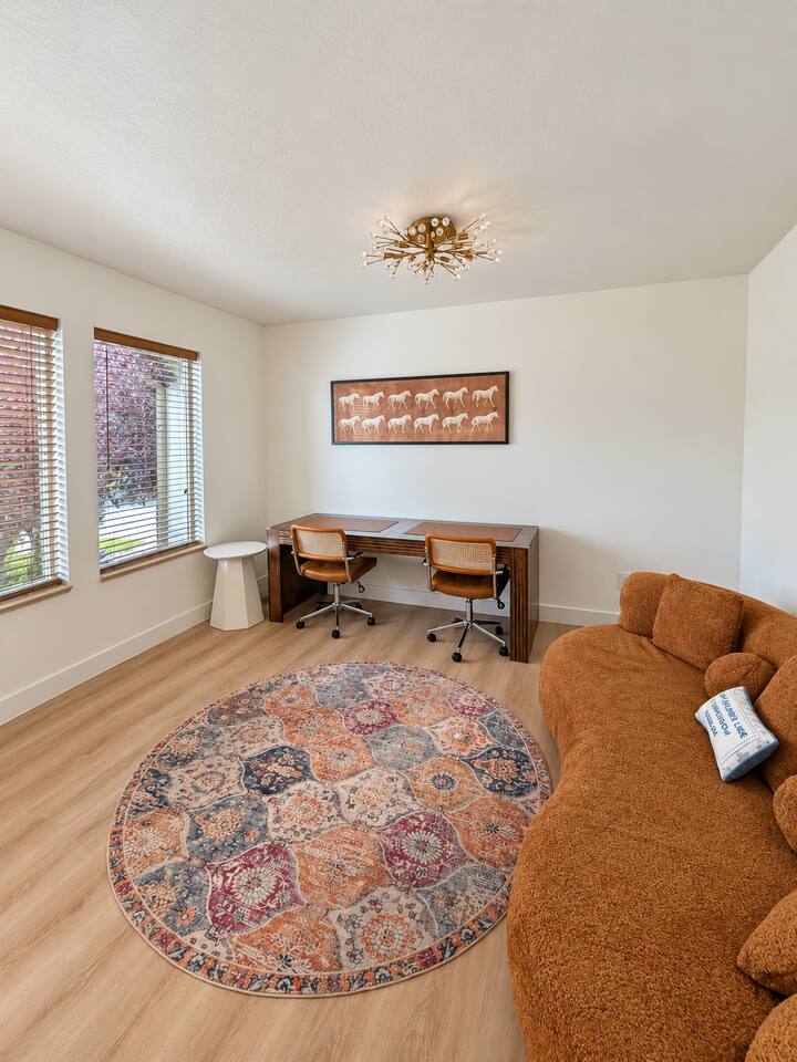 Den (Main Floor) with 2 seat desk and sofa