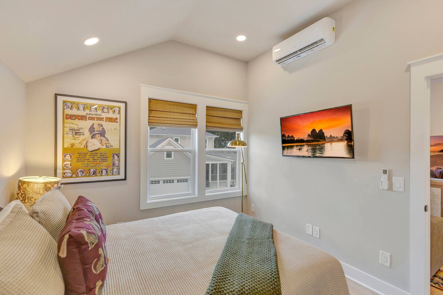 Stylish queen bedroom with smart TV.