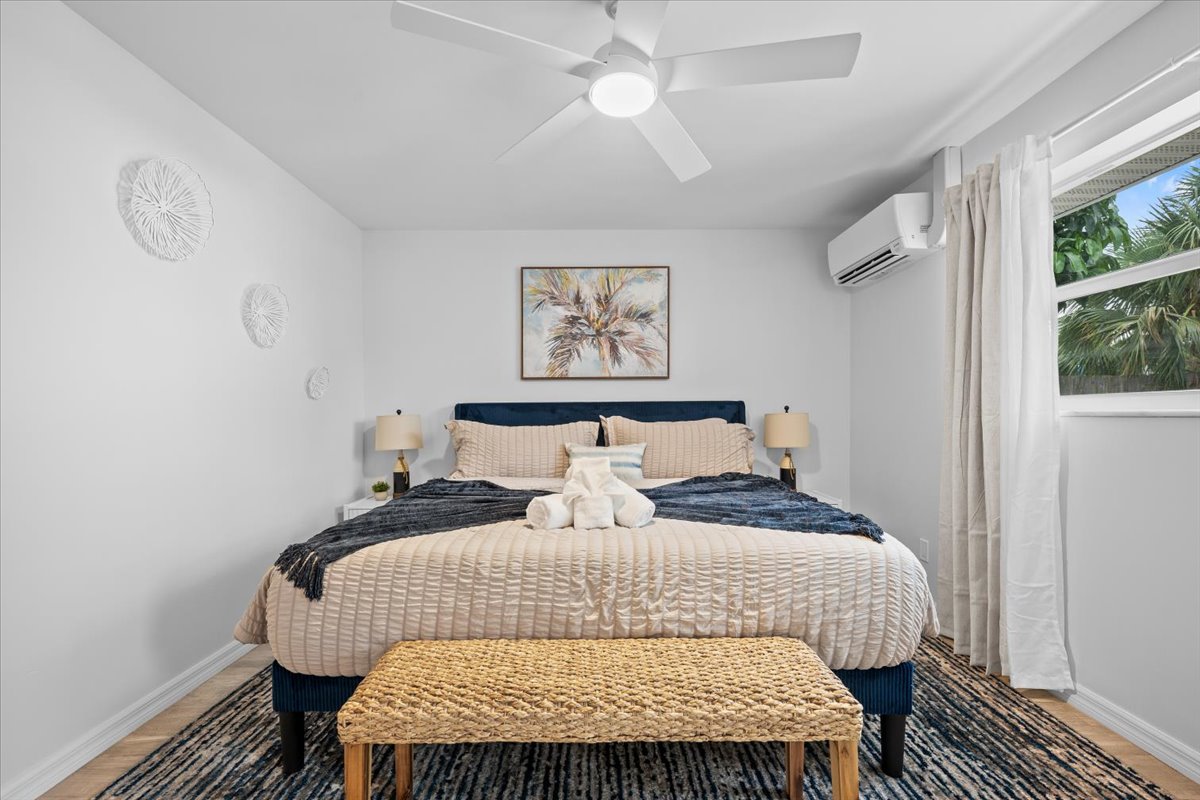 Bright tropical bedroom with plush king bed, AC, and serene modern styling