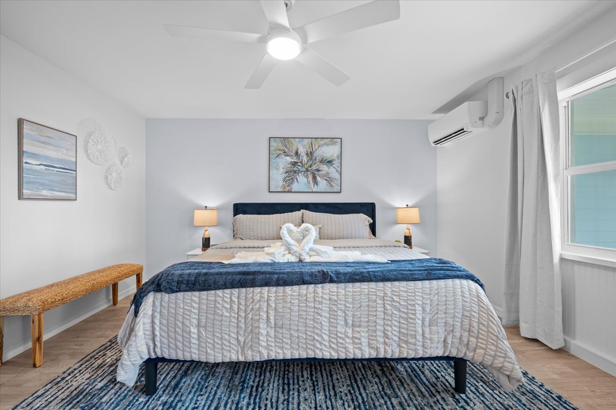 Bright coastal king bedroom with stylish decor and relaxing ambiance